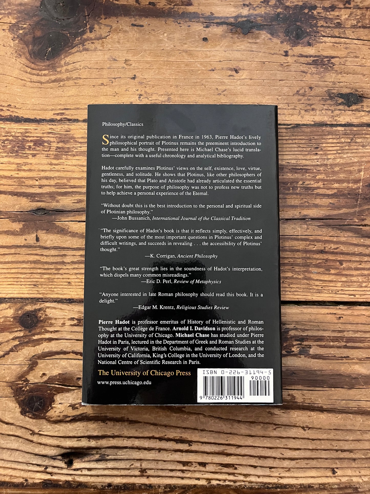 photo of the cover of the book "Plotinus" on a wooden background