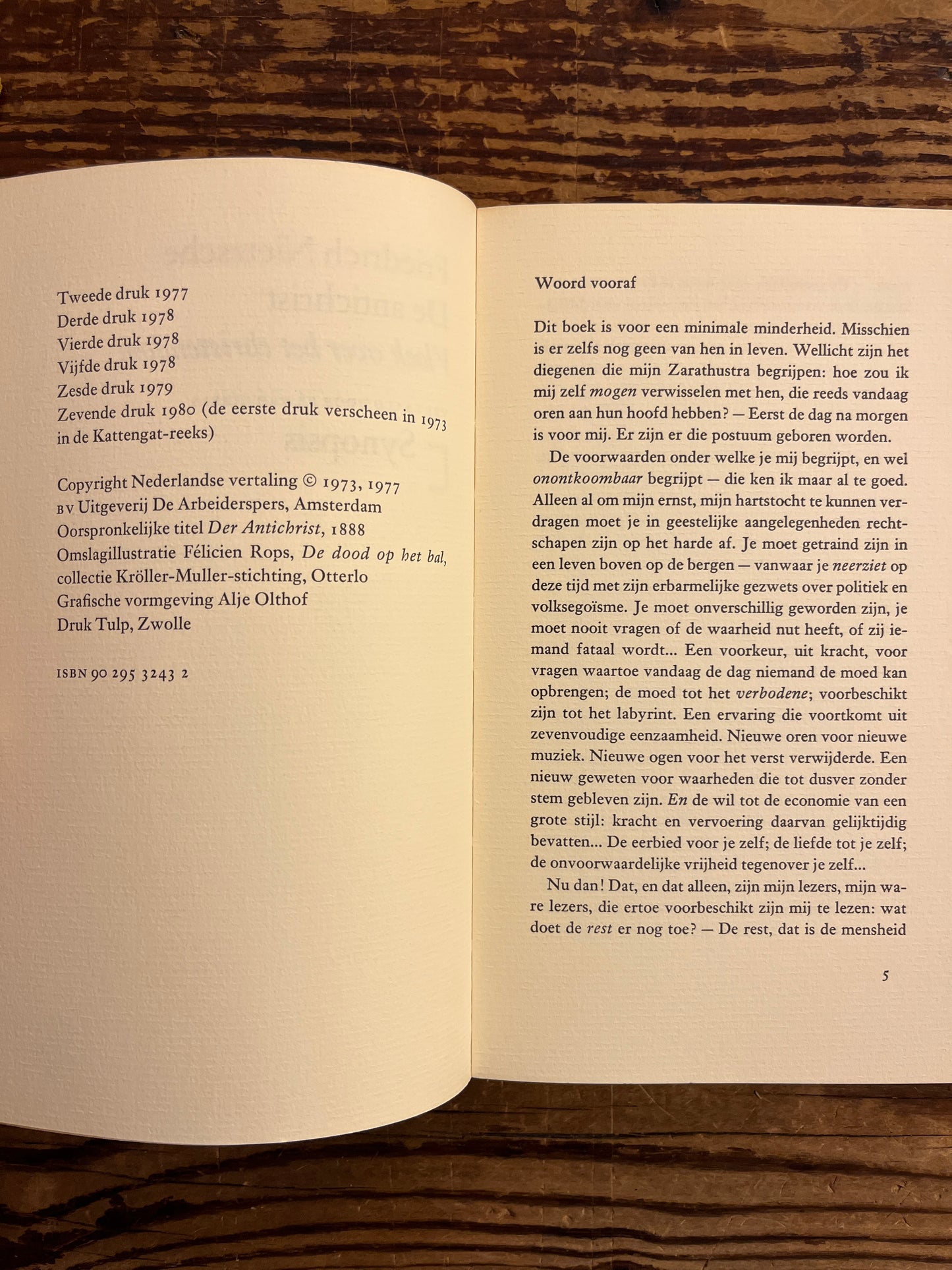 Open book on a wooden surface with text visible