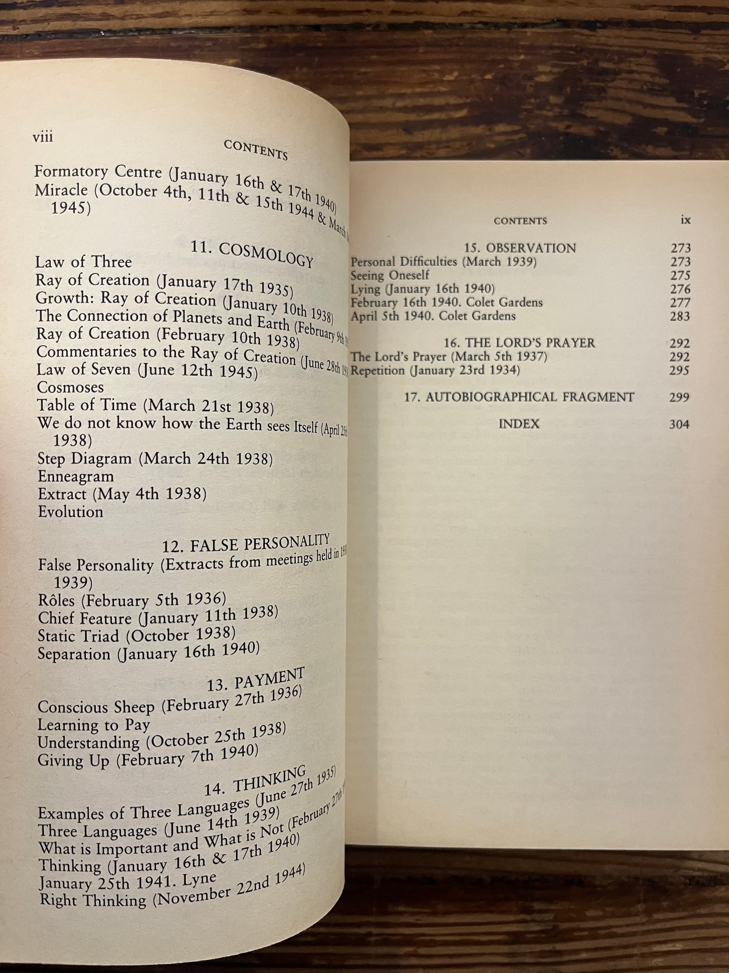Open book titled 'a further record' by P.D. Ouspensky on a wooden surface