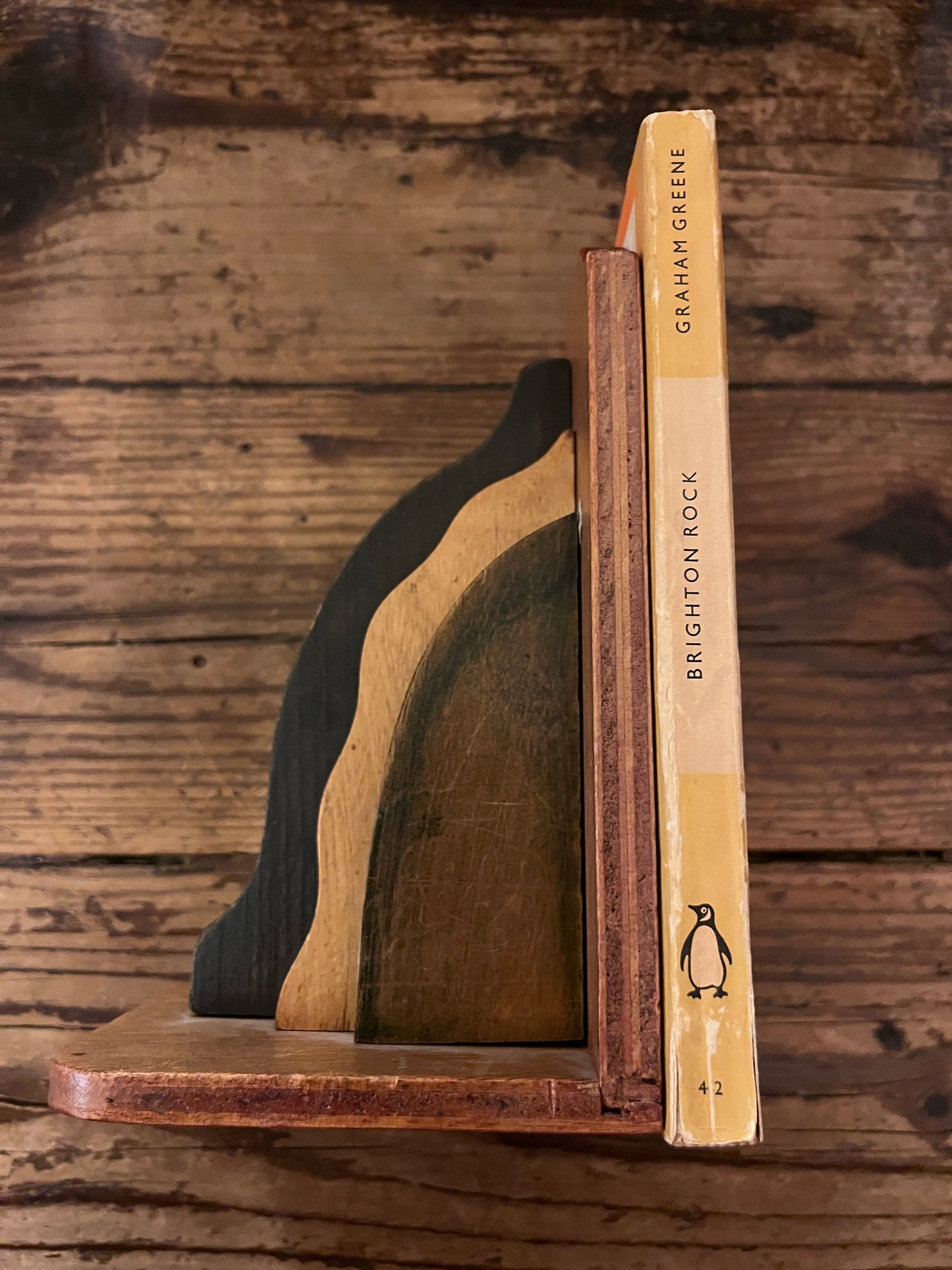 photo of the spine of the book "brighton rock"on a wooden background