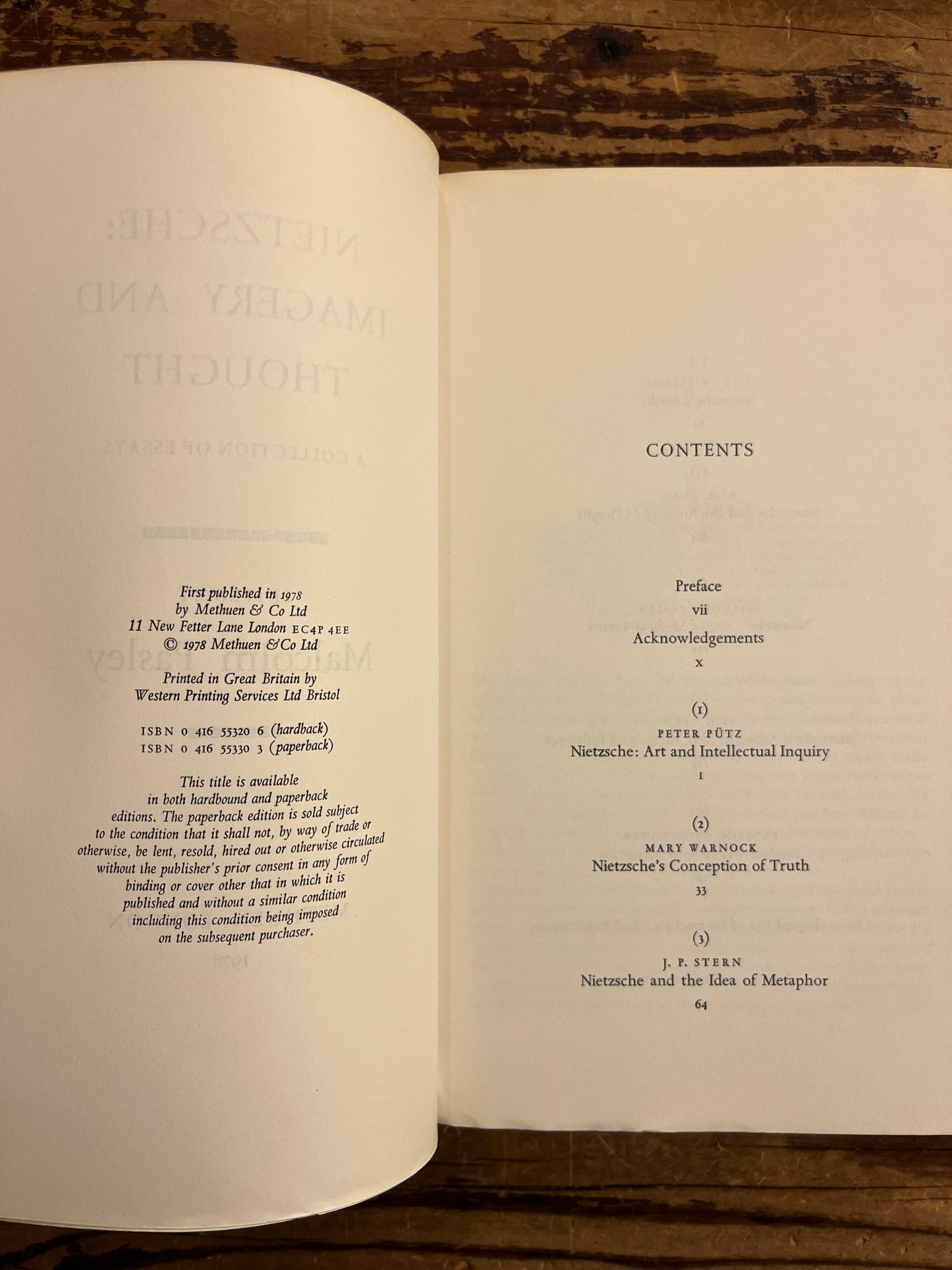 Open book showing a table of contents on a wooden surface