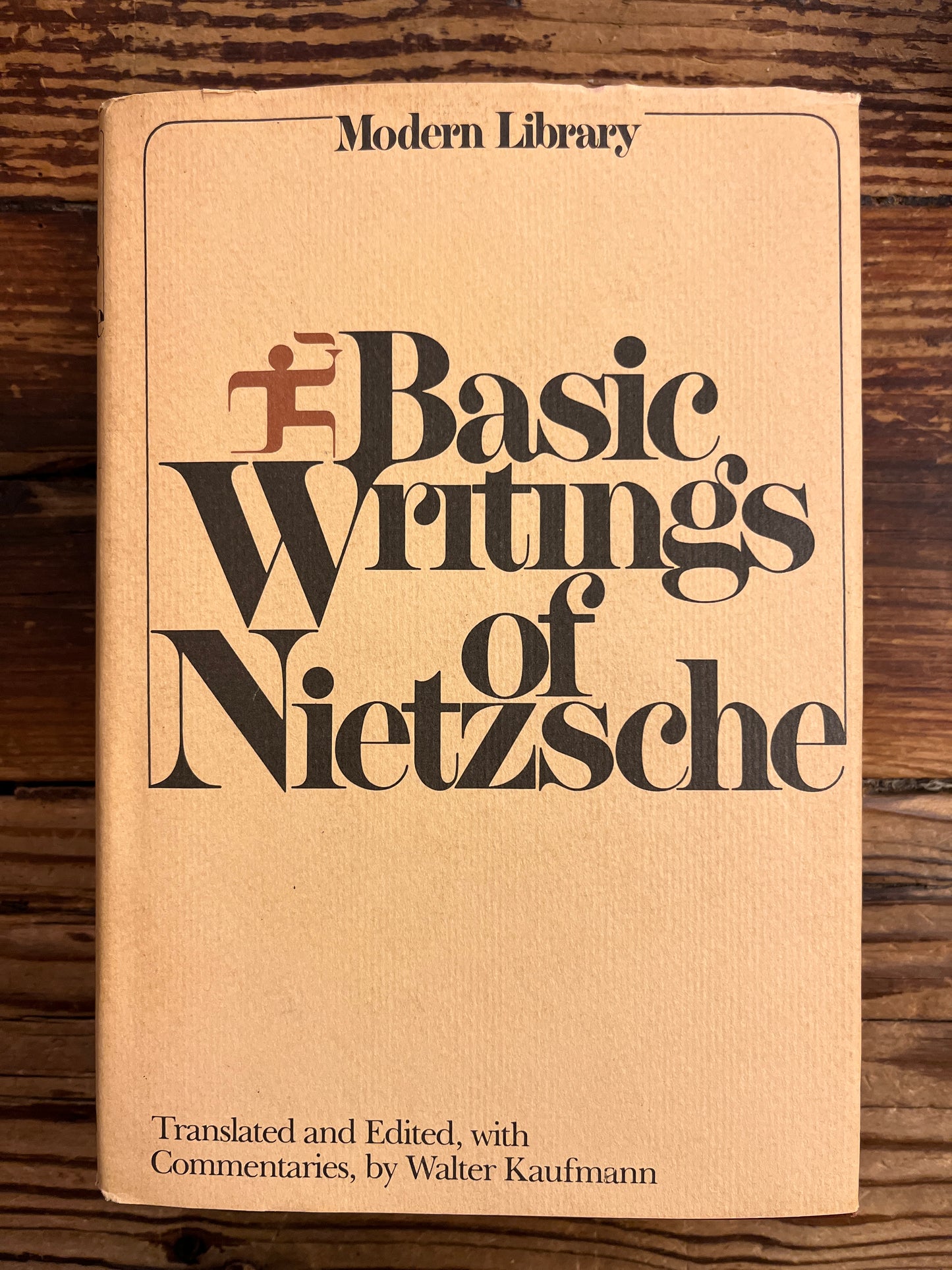 Book titled 'The Basic Writings of Nietzsche' on a wooden surface