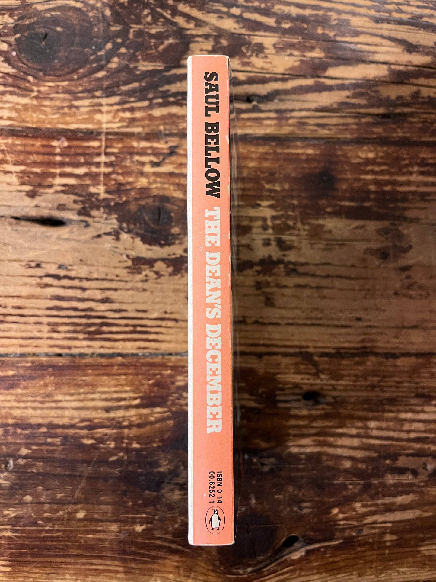 photo of the spine of the book " the dean's december" on a wooden background