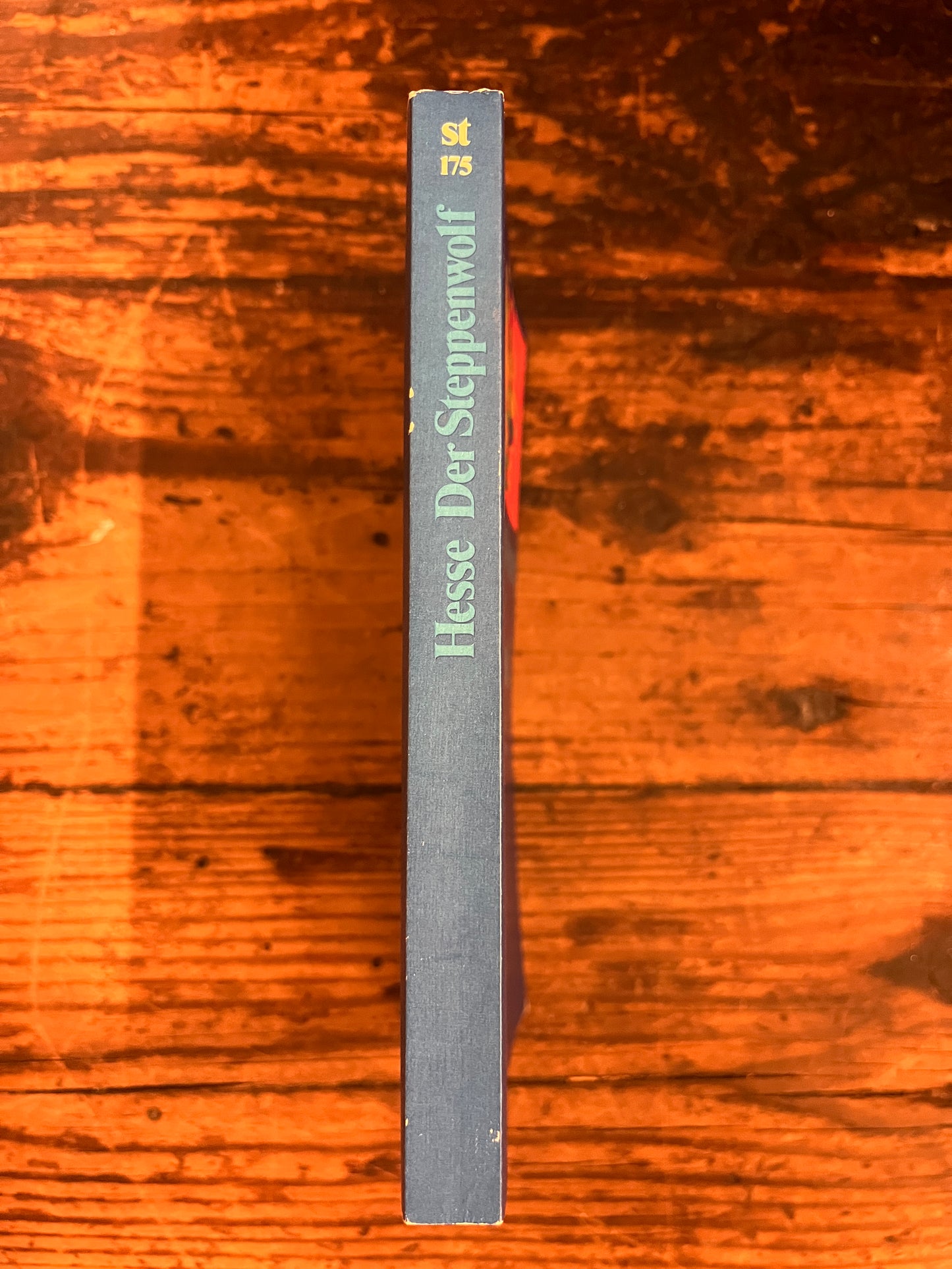 photo of the spine of the book "der steppenwolf" on a wooden background