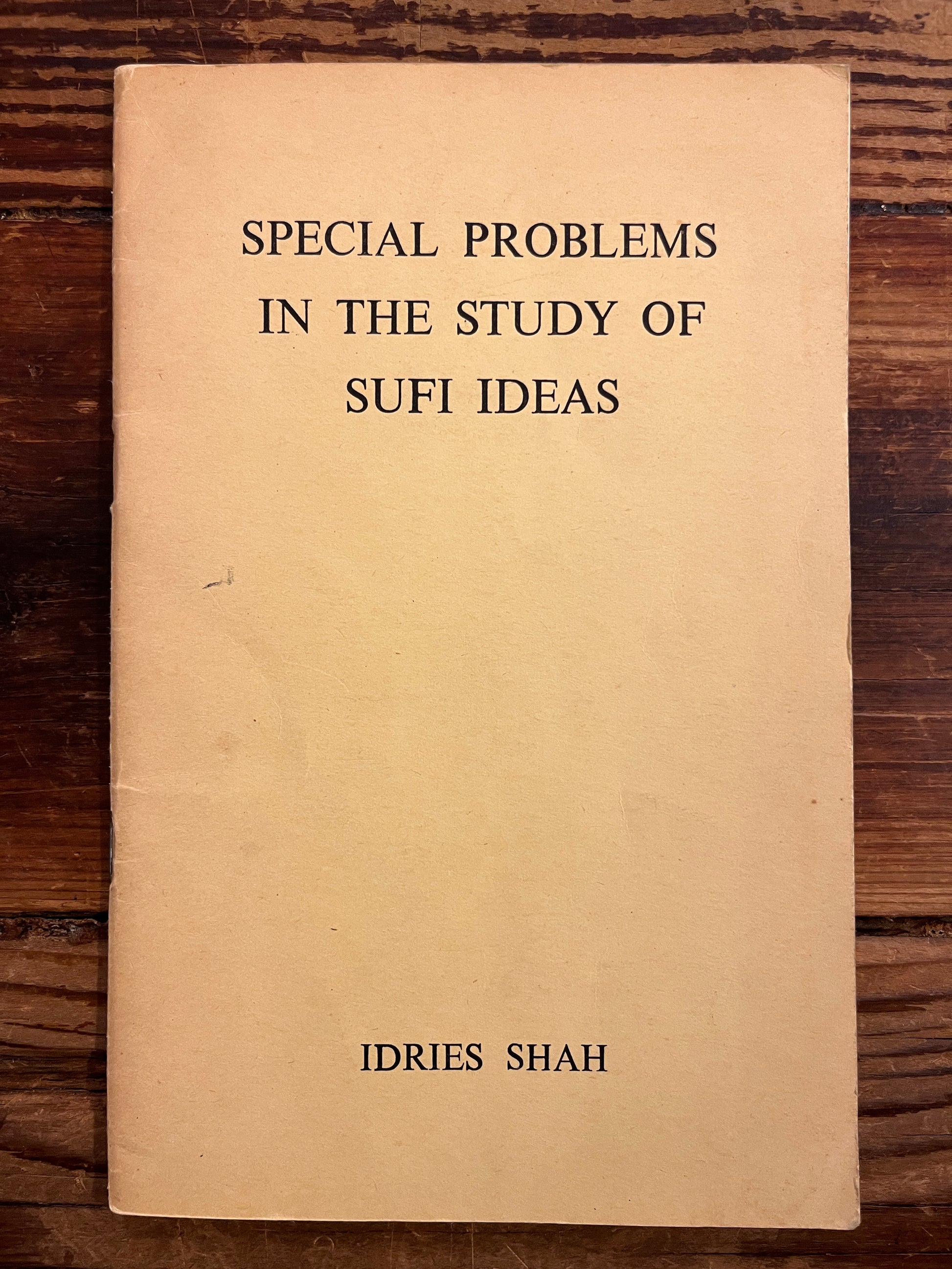 Book titled 'Special Problems in the Study of Sufi Ideas' by Idries Shah on a wooden surface
