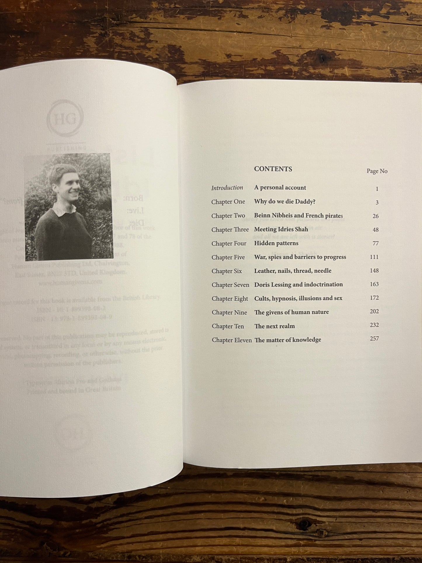 Open book titled 'Listening to Idries Shah' by Ivan Tyrrell with a table of contents on a wooden surface