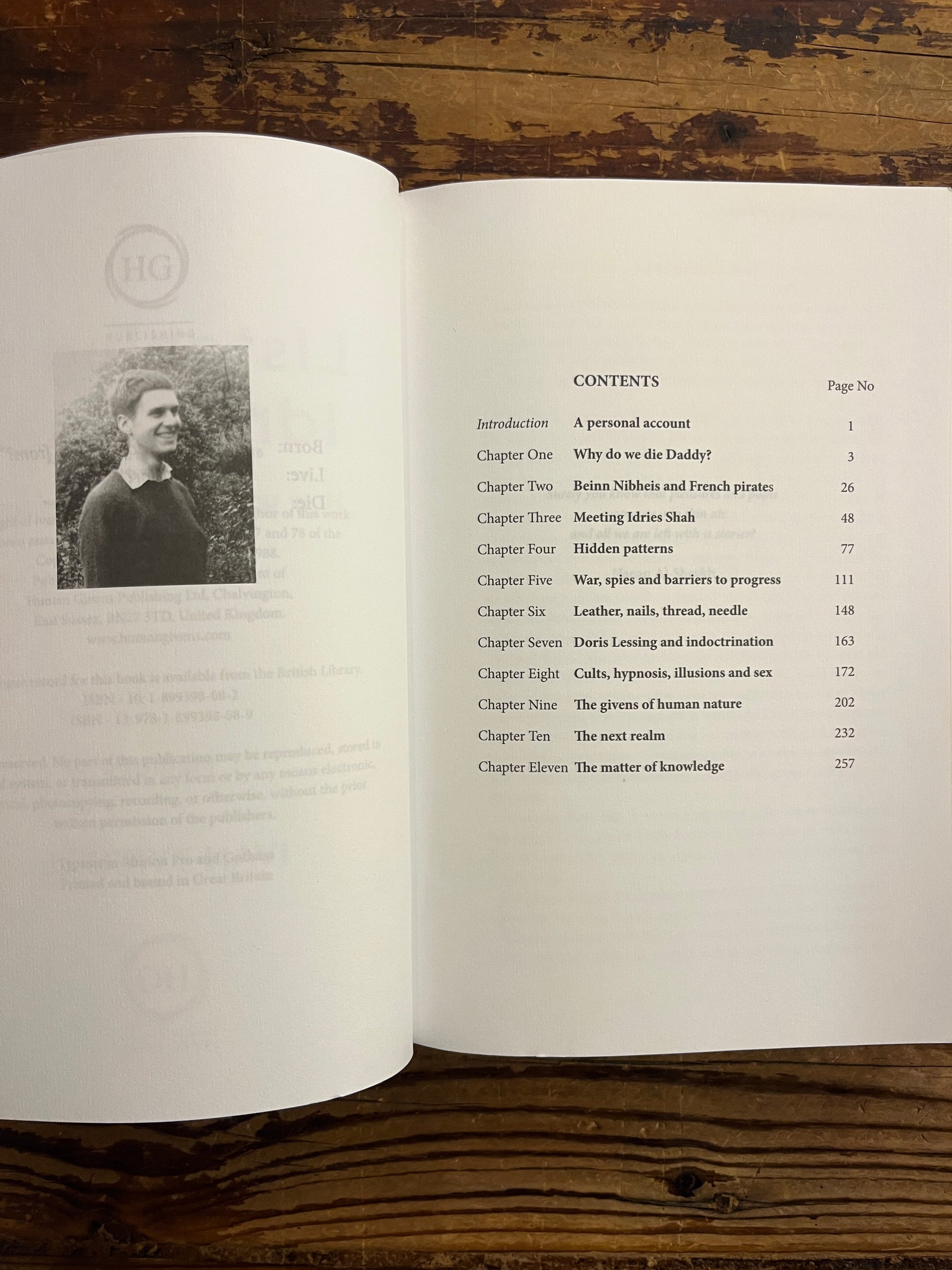 Open book titled 'Listening to Idries Shah' by Ivan Tyrrell with a table of contents on a wooden surface