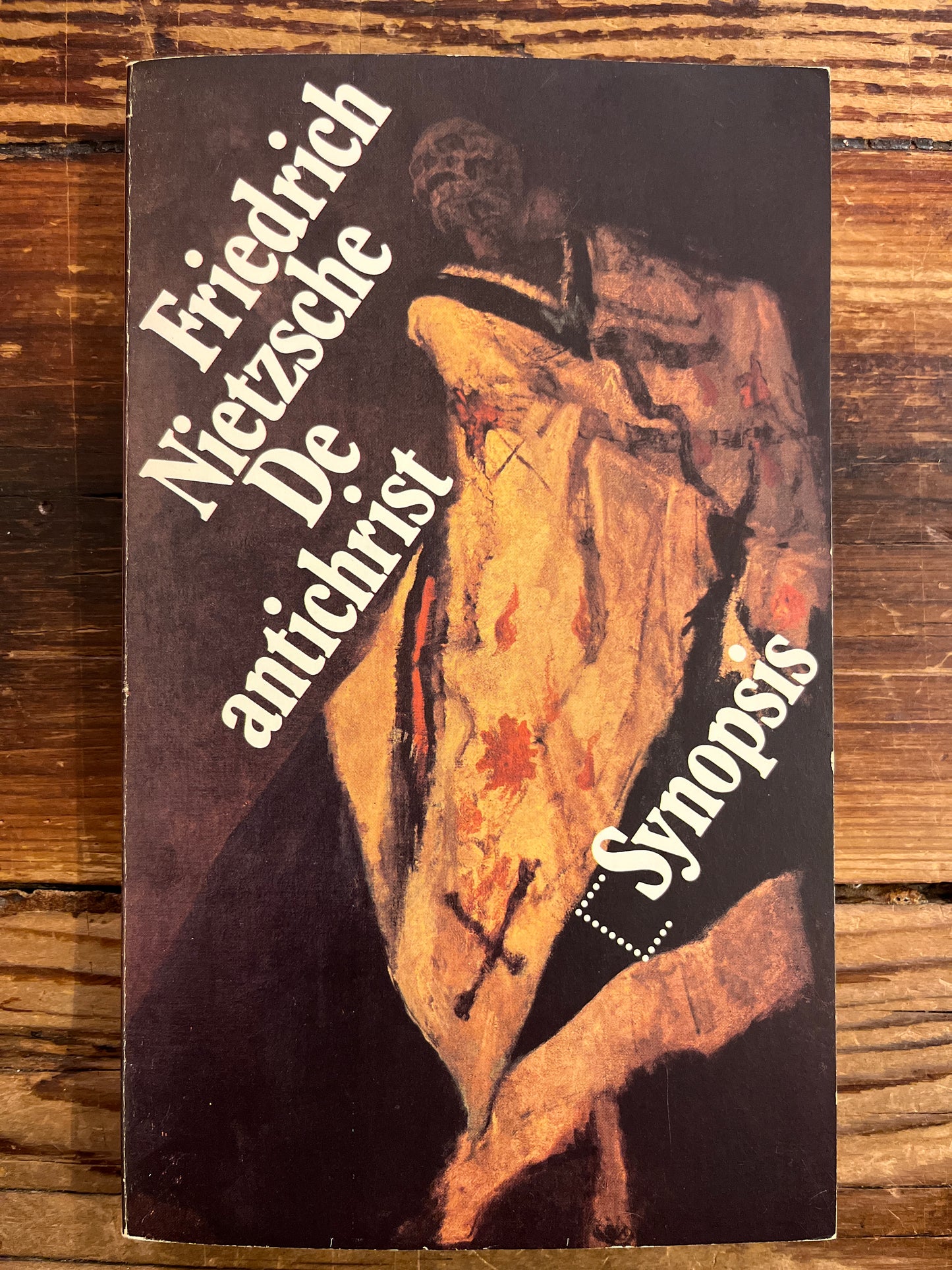 Book cover with text and artistic design on a wooden surface