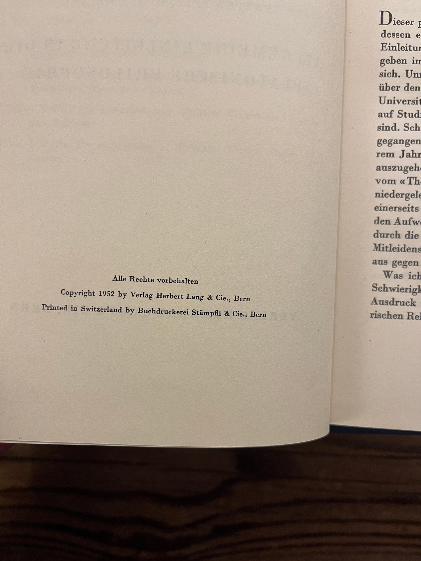 Open book titled 'Philosophischer Handkommentar zu den Dialogen Platos' by H. Gauss on a wooden surface