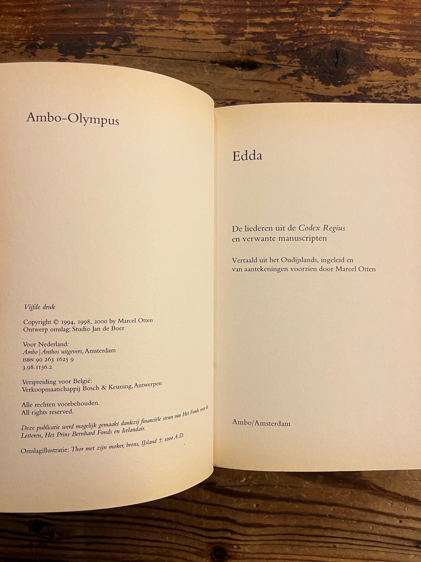 Open book on a wooden surface with visible text