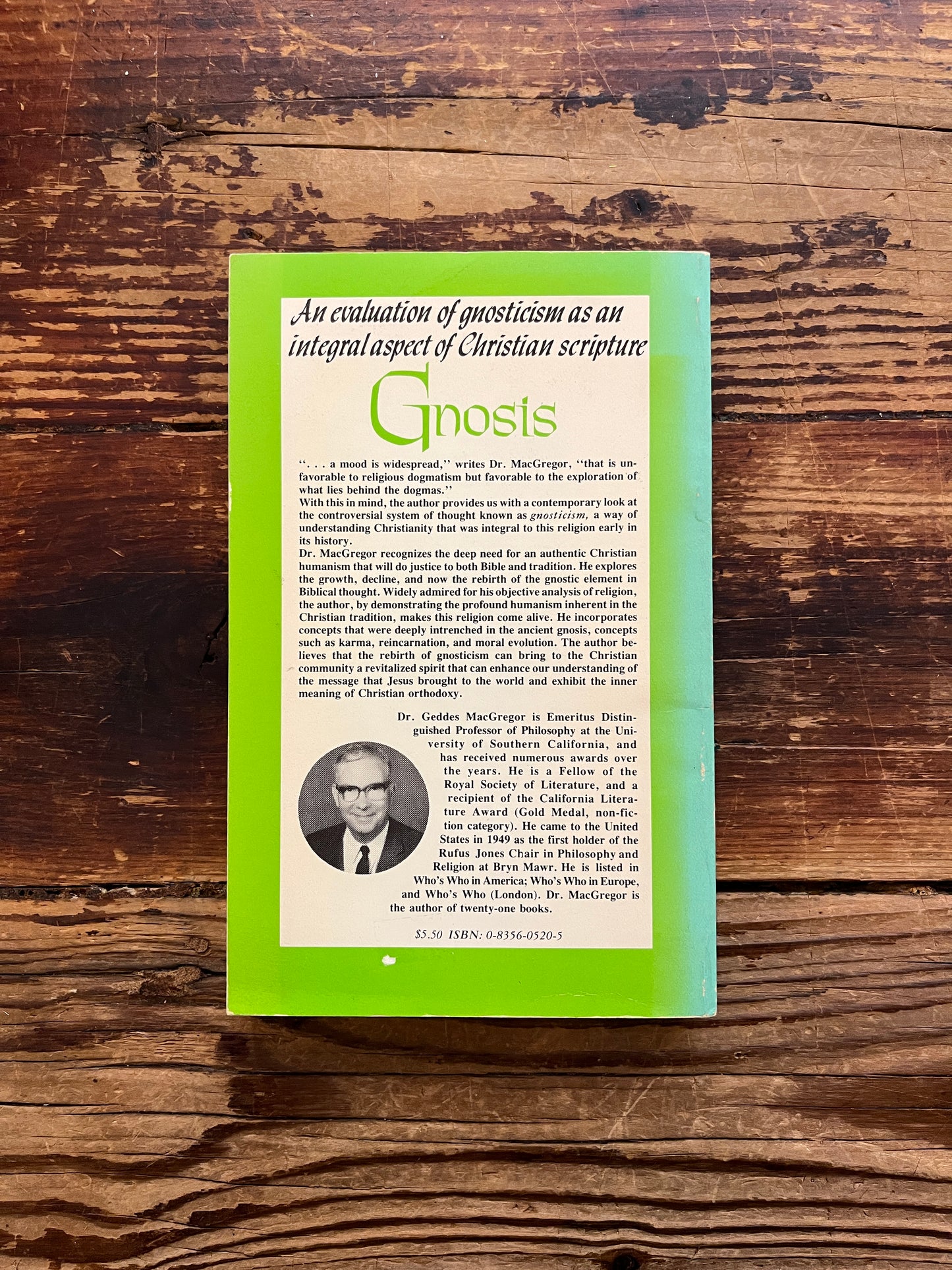Back cover of book titled 'Gnosis' by Geddes MacGregor on a wooden surface