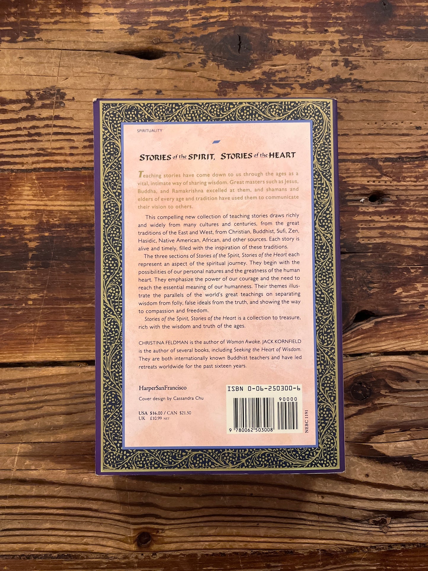 Book titled 'Stories of the Spirit, Stories of the Heart' on a wooden surface