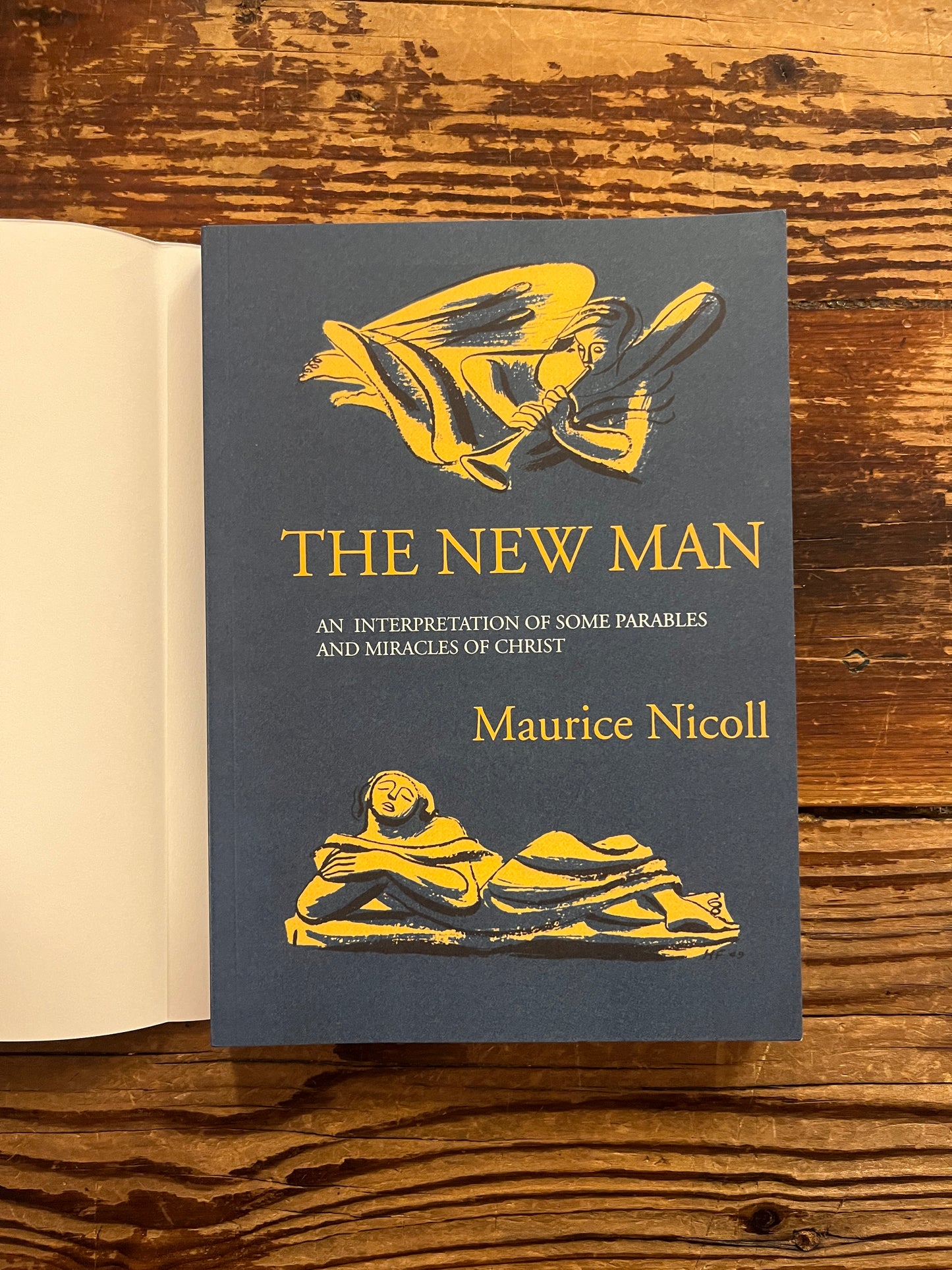 Cover of 'the New Man' by Maurice Nicoll on a wooden surface