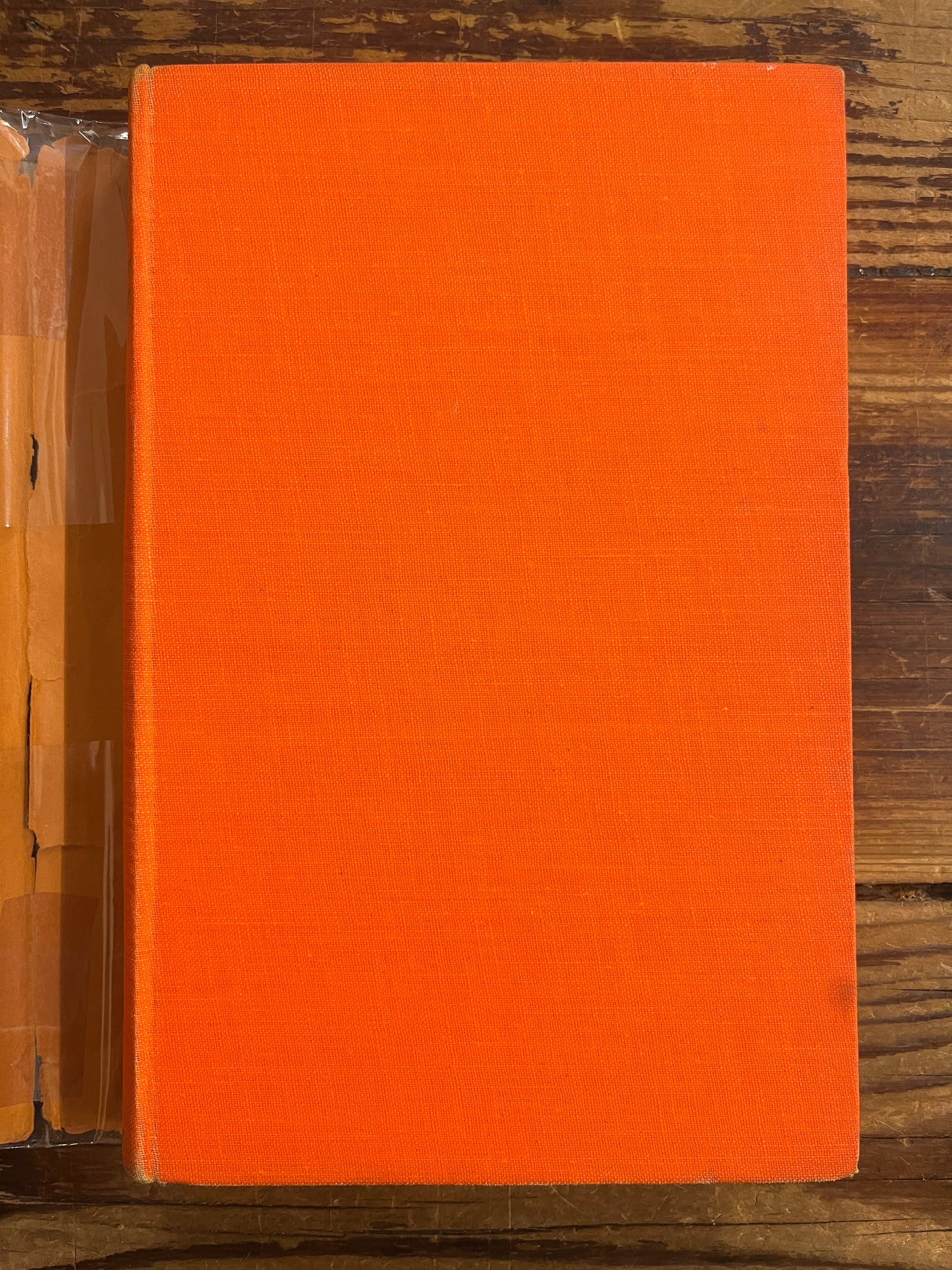 Orange cloth book on a wooden surface