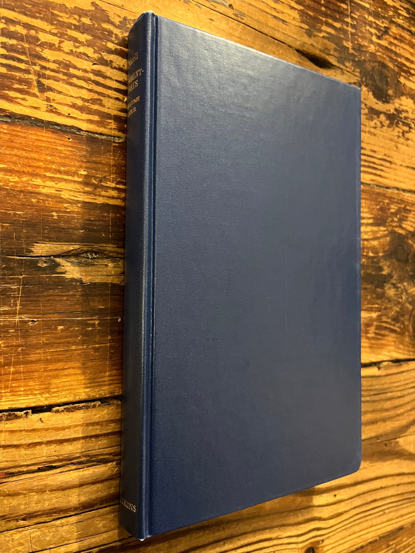 Book without dust jacket titled 'Psychological Commentaries on the Teaching of Gurdjieff & Ouspensky volume 4' by Maurice Nicoll on a wooden surface