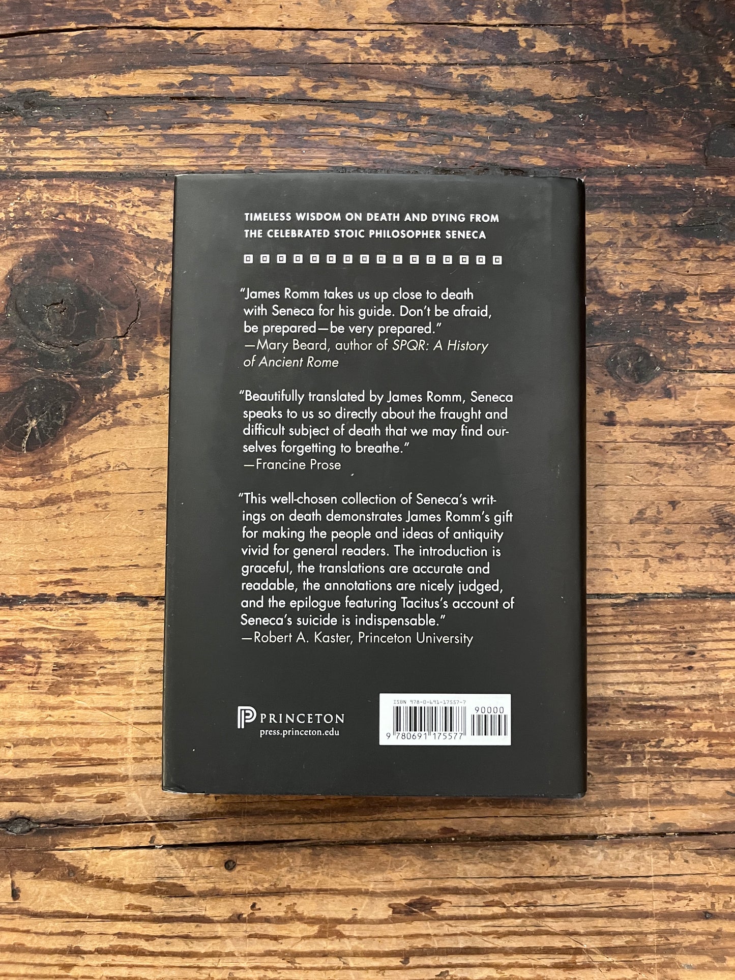 photo of the backcover of the book "how to die" on a wooden background