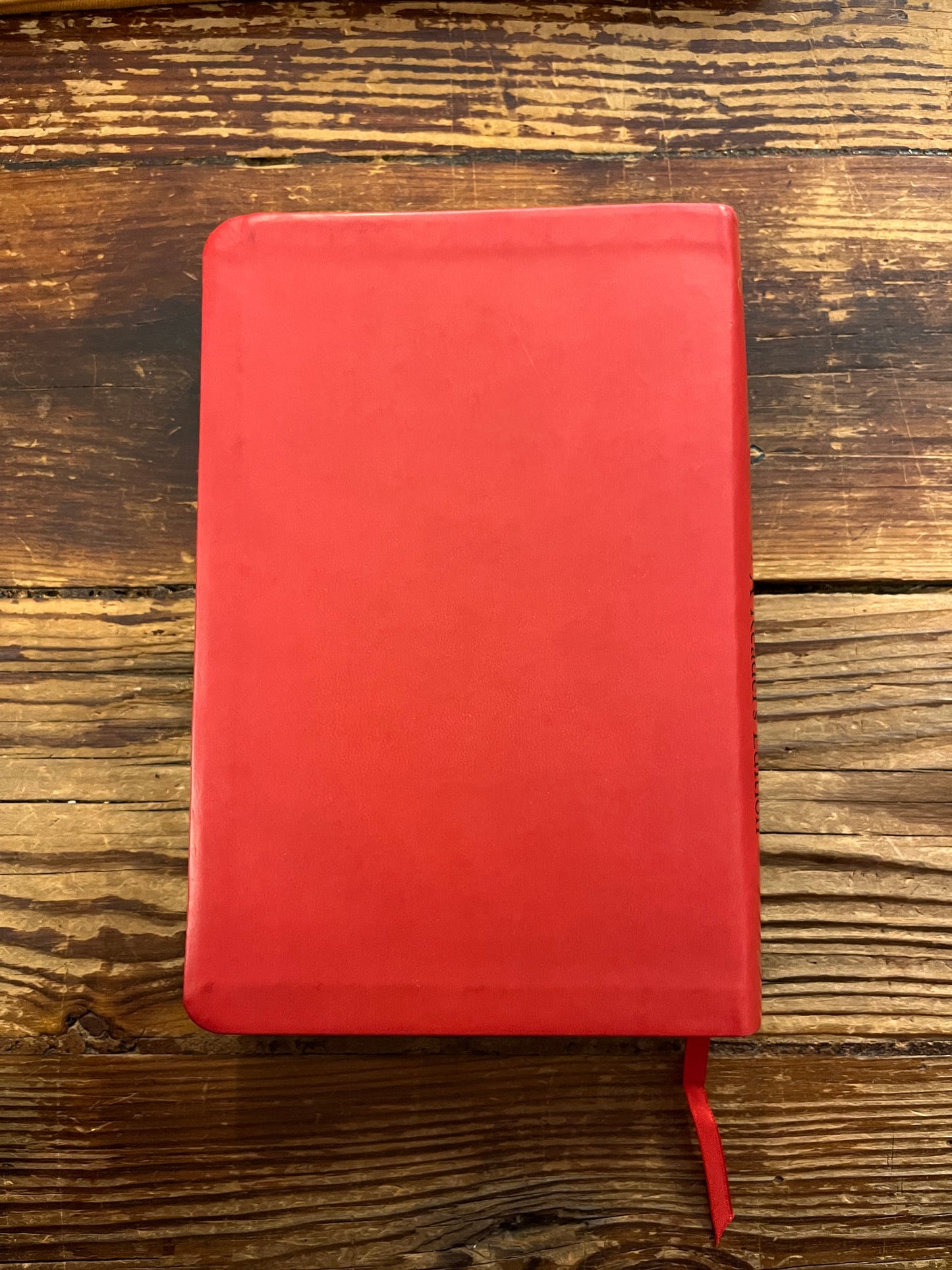 Book titled 'The Red Book' by C.G. Jung on a wooden surface