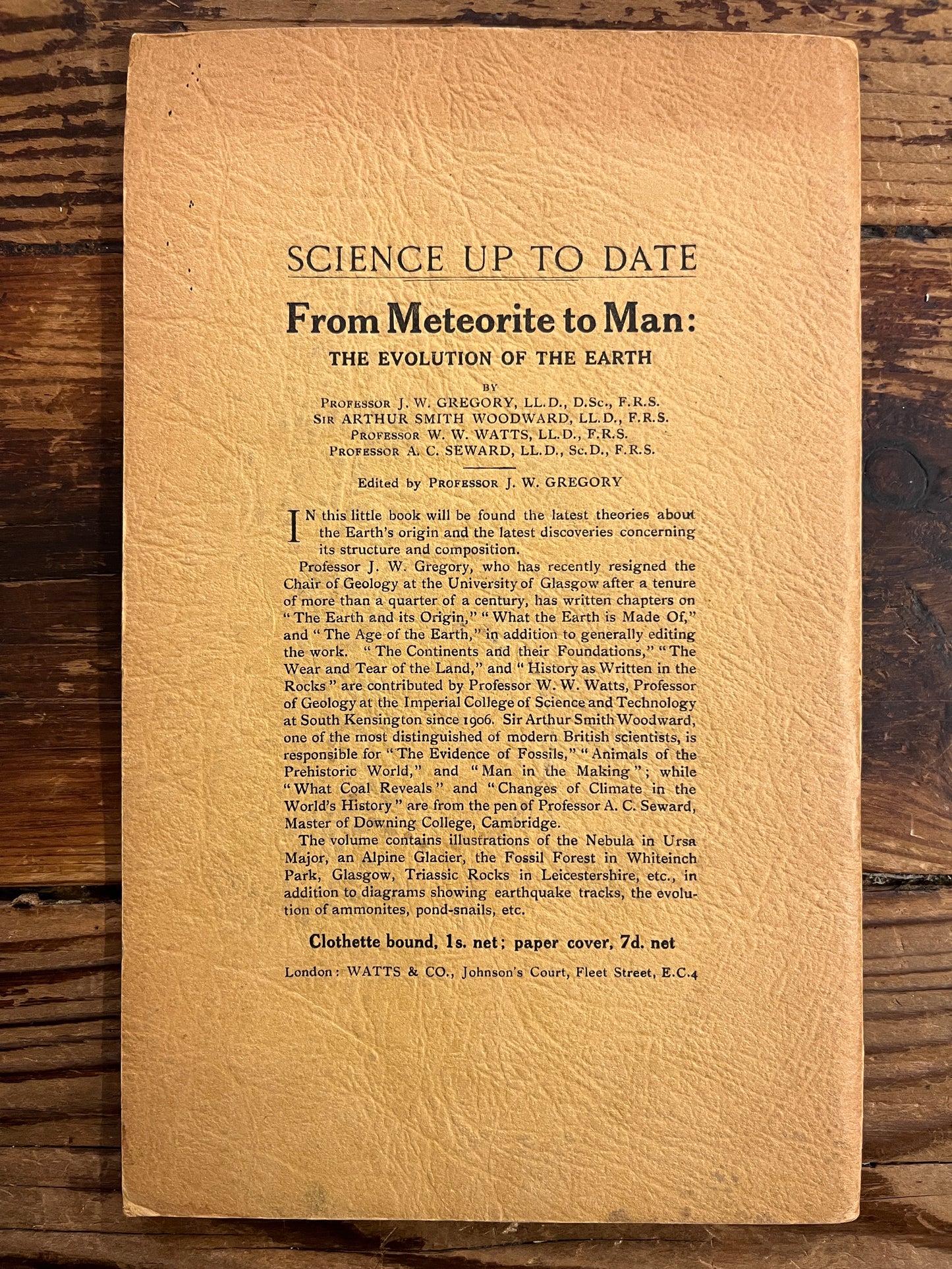 Vintage back cover of a booklet with text on a wooden surface