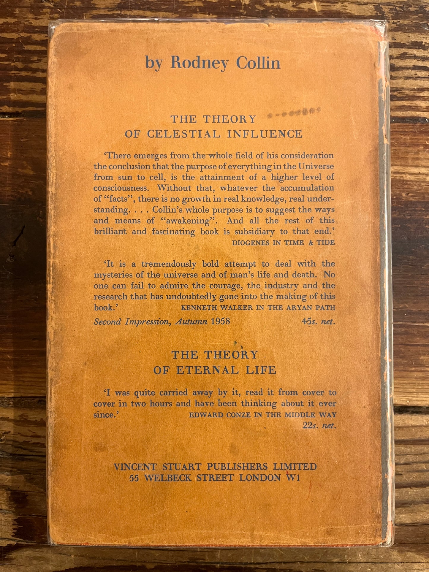 back cover of book titled 'theory of conscious harmony' on wooden surface