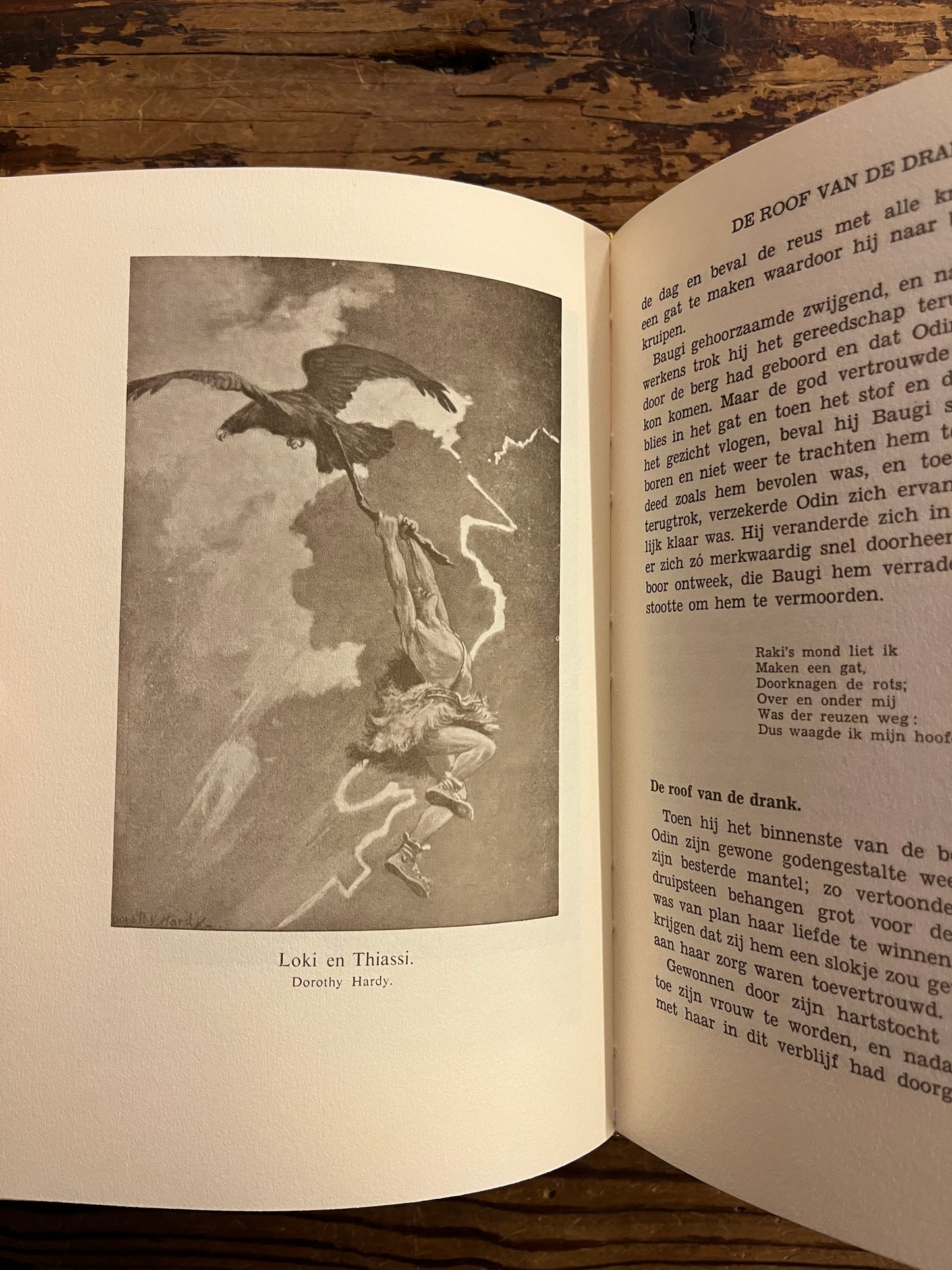 Open book with Loki en Thiassi by Dorothy Hardy on a wooden surface