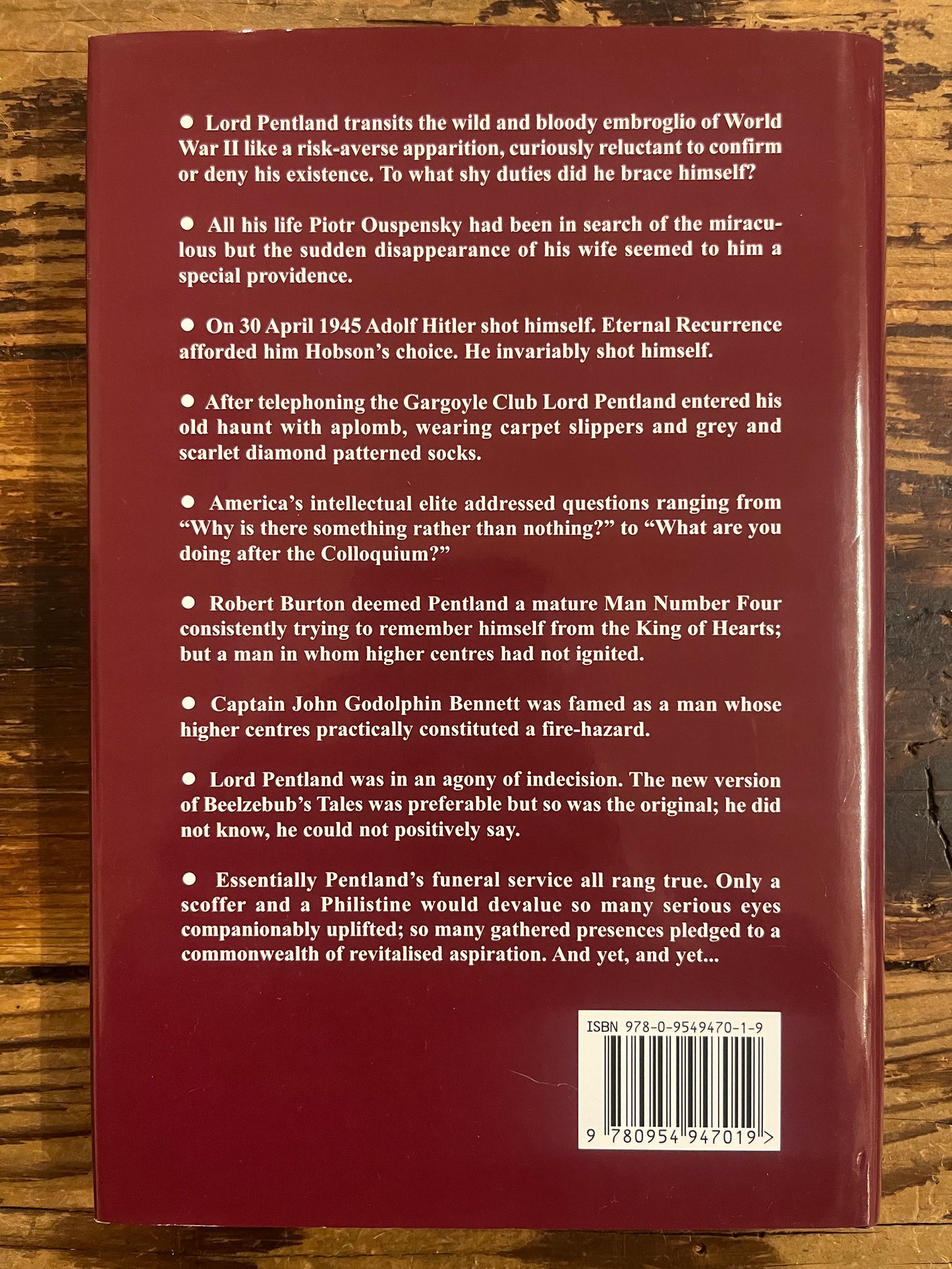 Back cover of a book with text and a barcode on a wooden surface