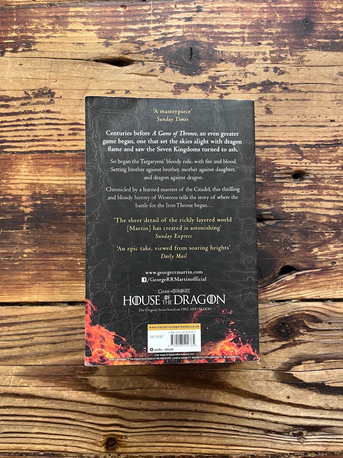 Book titled 'Fire and Blood' by George R.R. Martin on a wooden surface