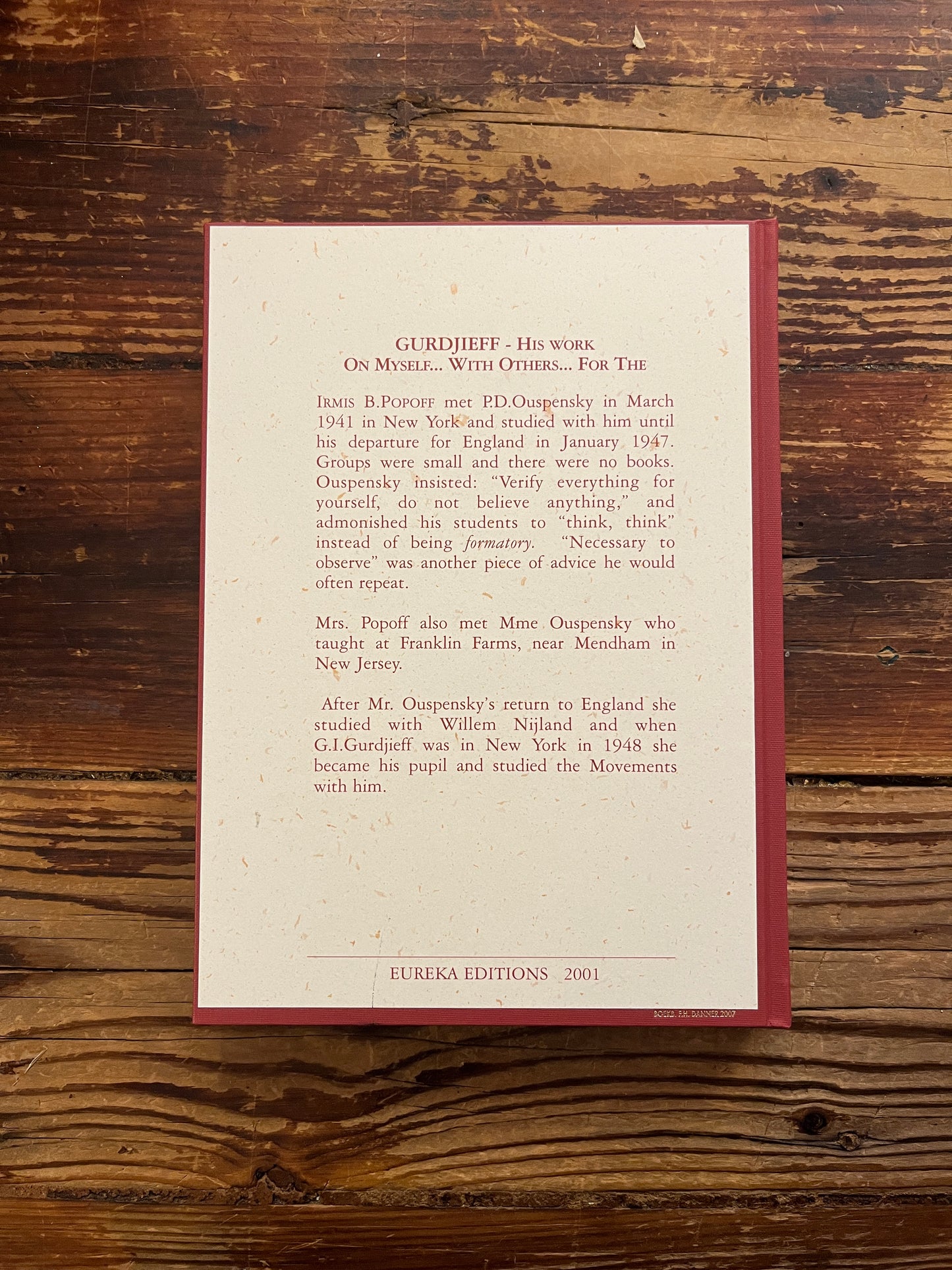 Back cover of book titled 'Gurdjieff, His work, on myself, with others, for the work' by Irmis B. Popoff on a wooden surface