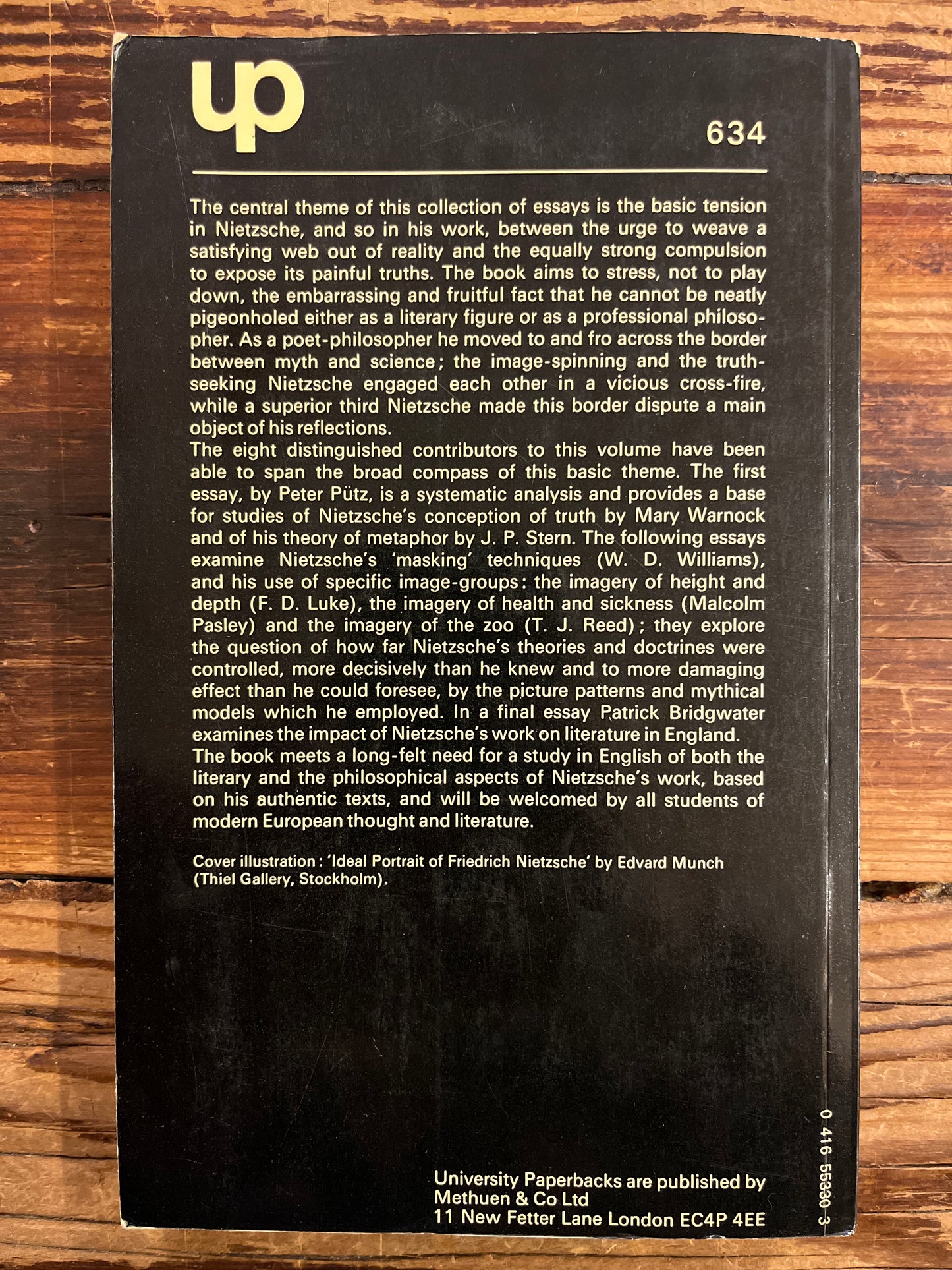 Back cover of a book with text and a logo on a wooden surface