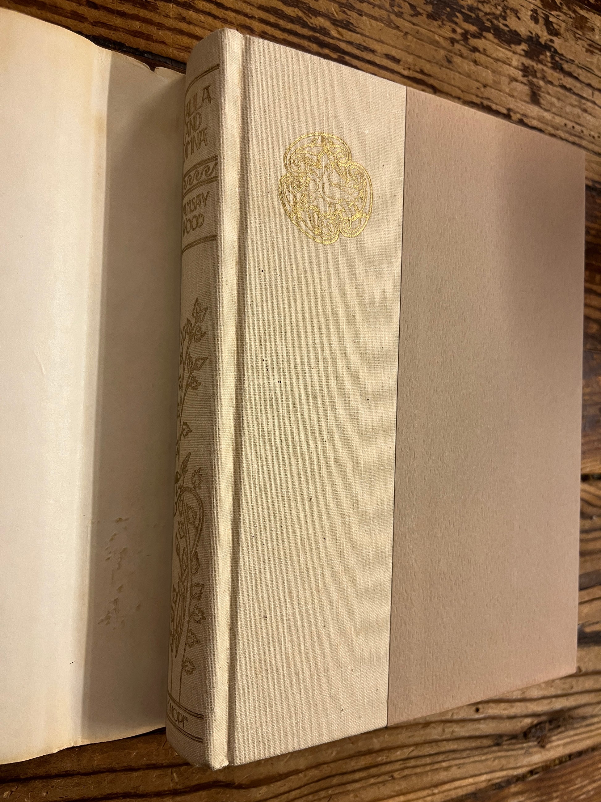 Spine a front cover view of book without dust jacket titled 'Kalila and Dimna, selected Fable of Bidpai' retold by Ramsay Wood, on a wooden surface