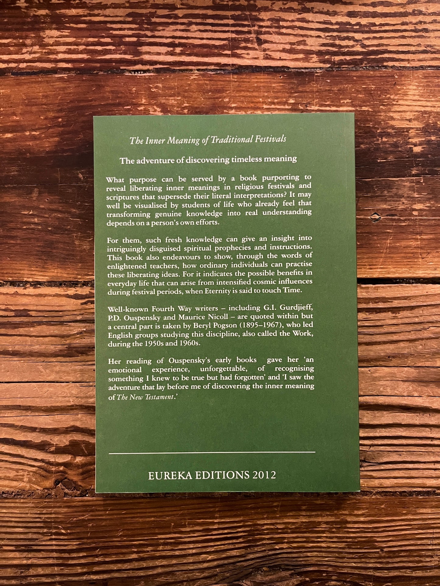 Back cover of book titled 'The Inner Meaning of Traditional Festivals' by Bob Hunter on a wooden surface