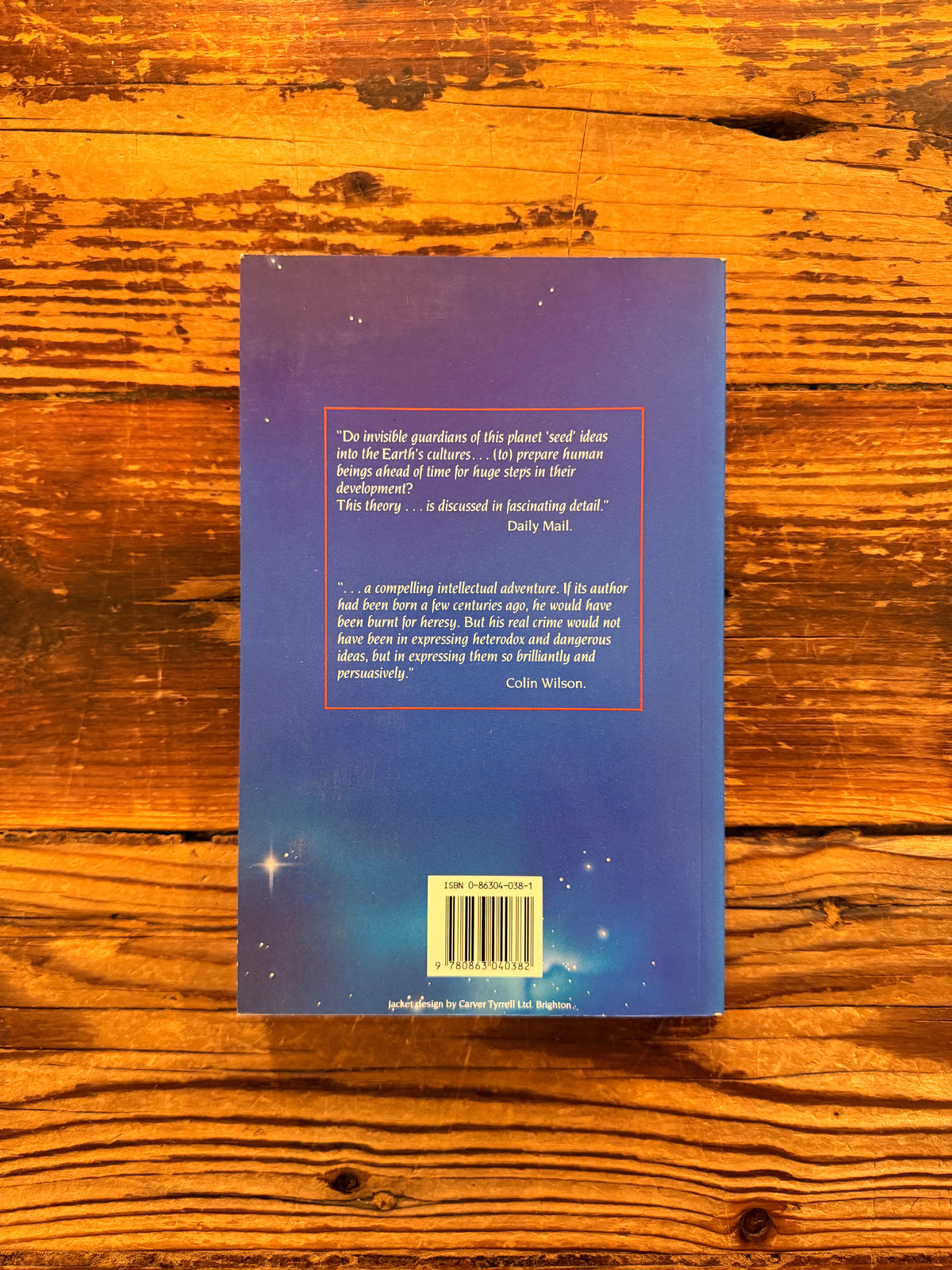 Back cover of book with the title 'The People of the Secret' by Ernest Scott lying on a wooden surface
