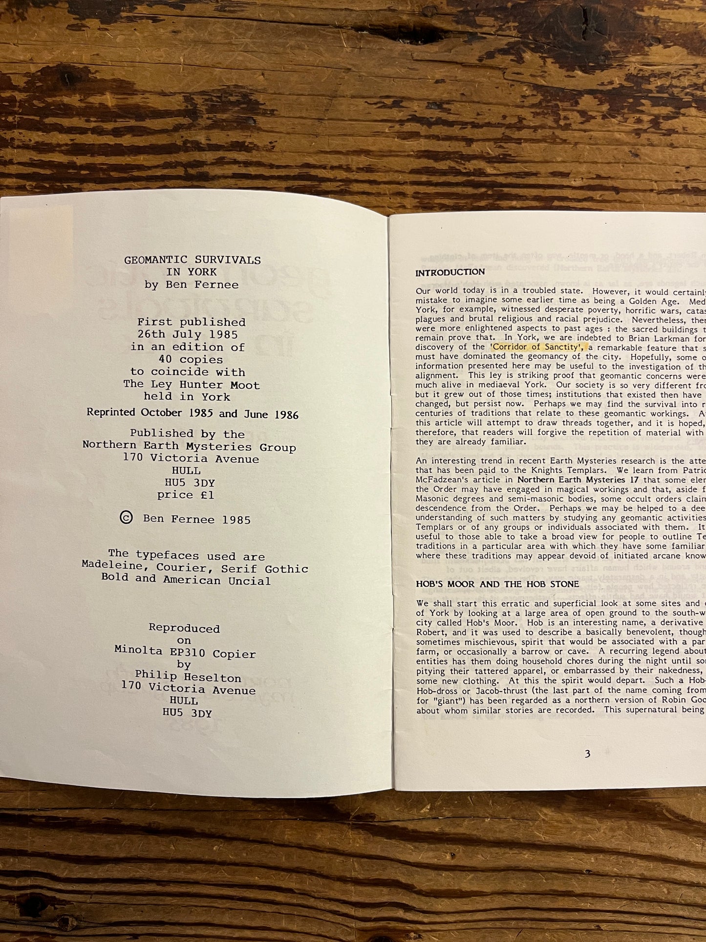 Open book on a wooden surface with text visible