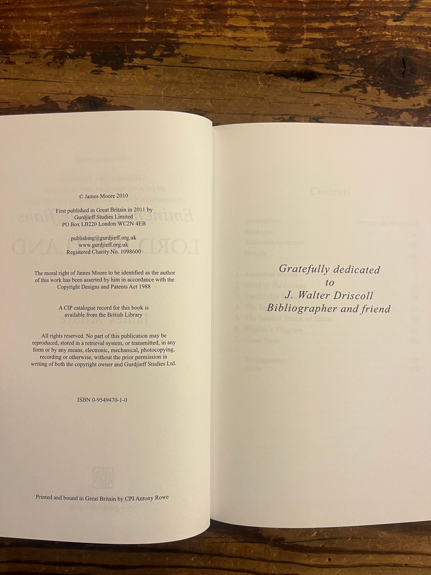 Open book on a wooden surface with text visible