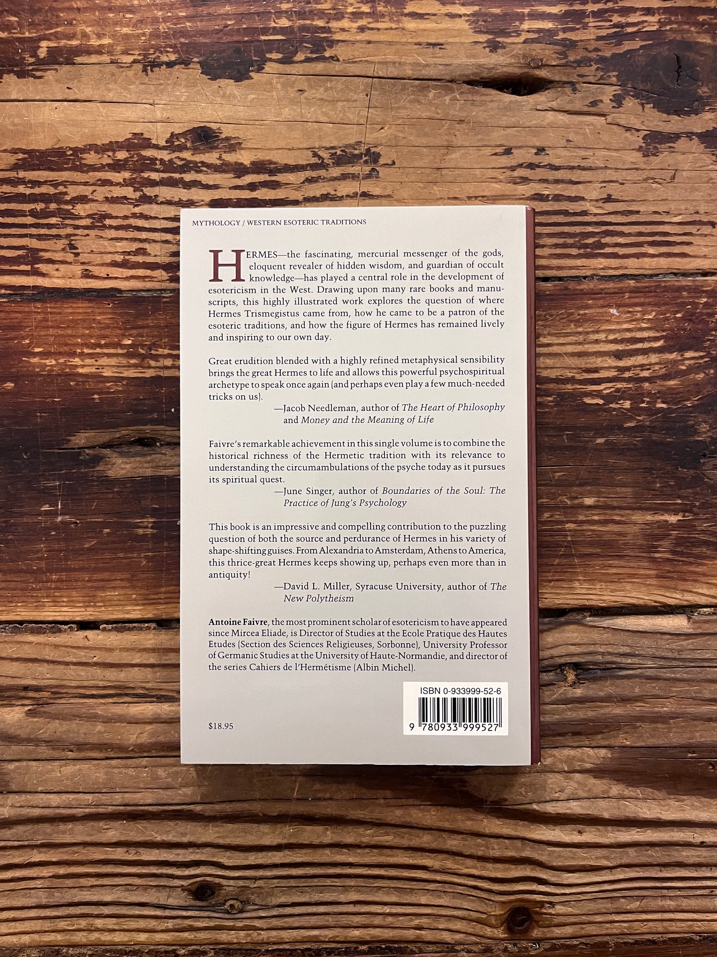 Back cover of the book titled 'the eternal Hermes' by Antoine Faivre on a wooden surface
