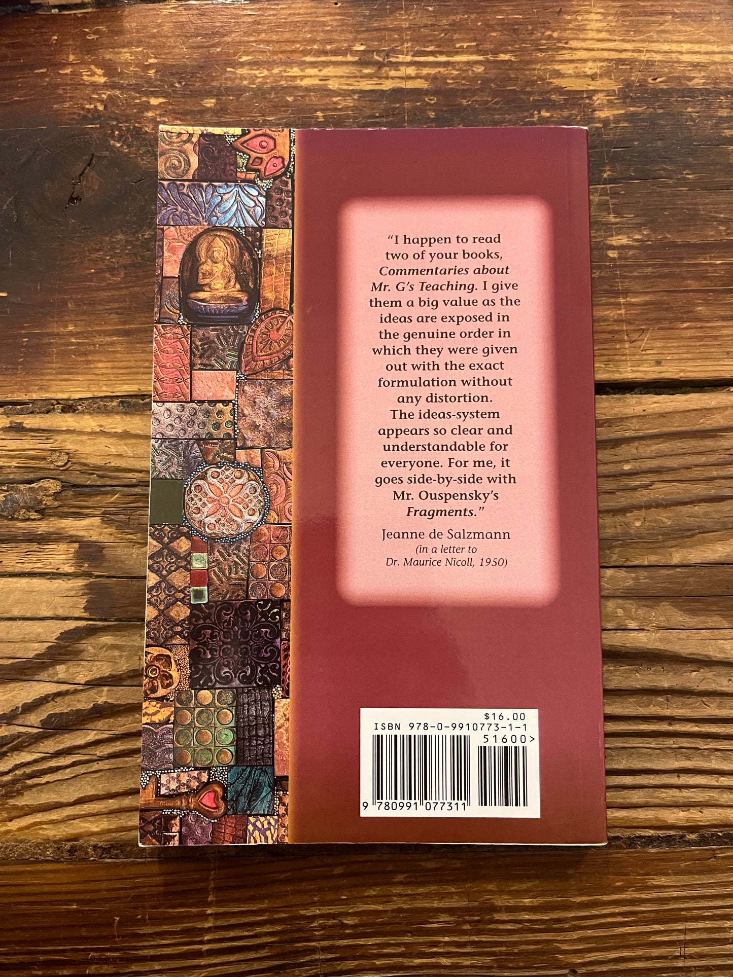 Back cover of book titled 'Gems of Wisdom' by Maurice Nicoll on a wooden surface