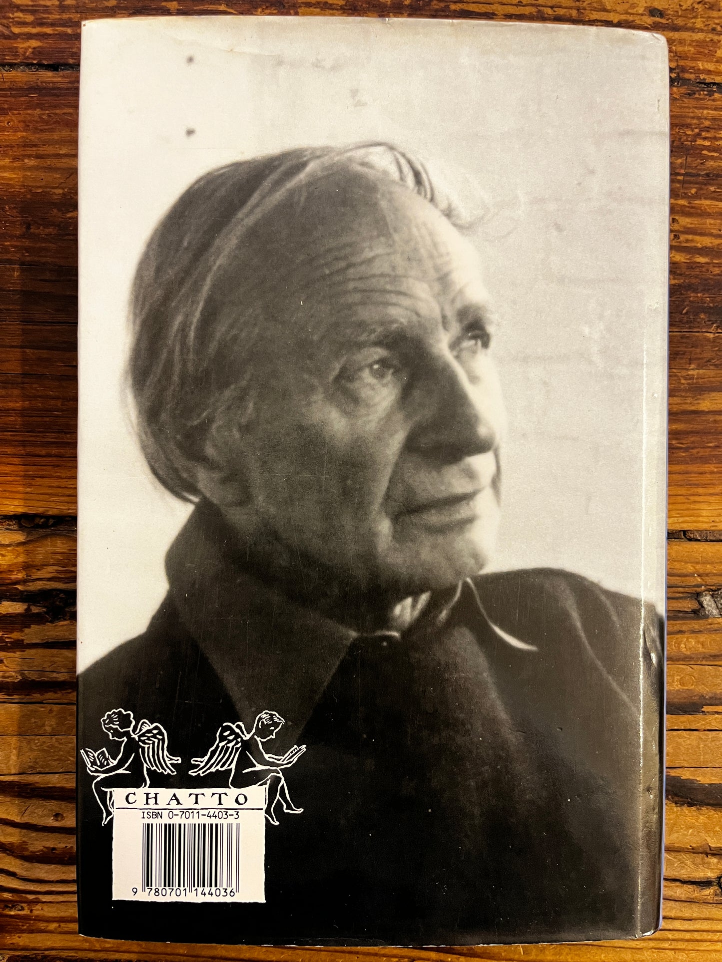 Back cover with photo of Laurens van der Post on a wooden surface