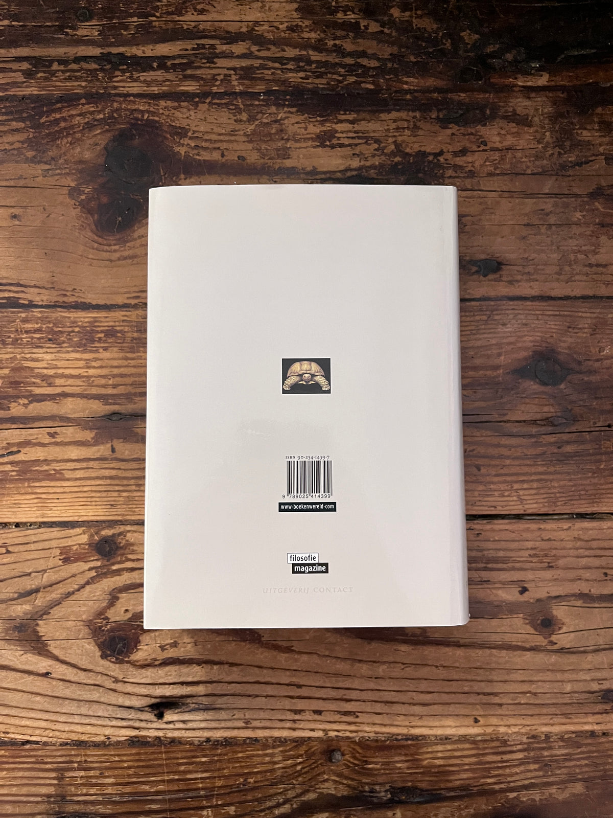 foto van de omslag van het boek " de mens is een dier dat kan denken " op houten achtergrond