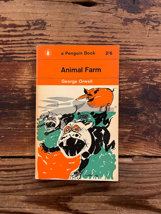 Front cover of book titled 'Animal farm' by George Orwell on a wooden surface