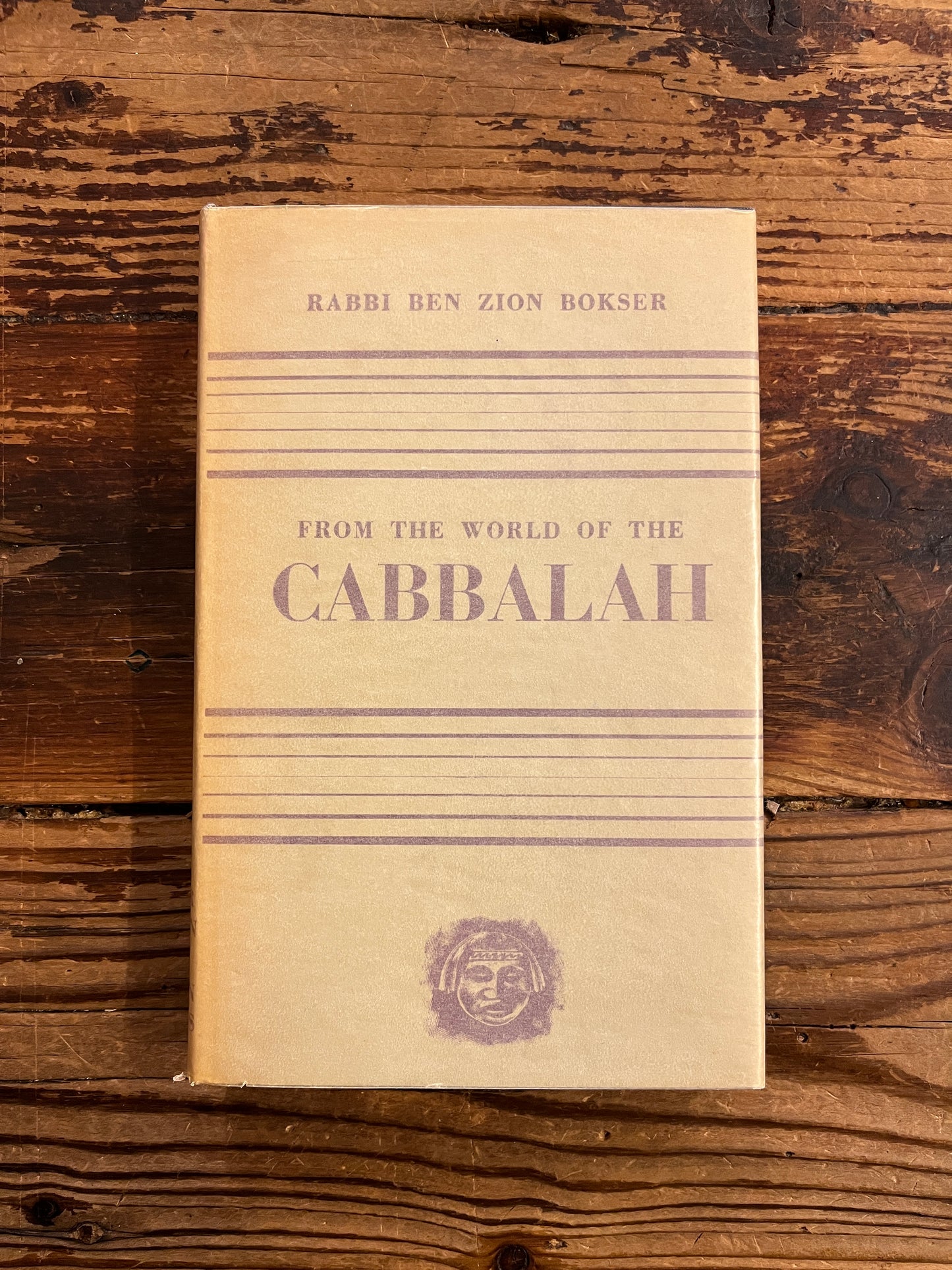 Front cover of book titled 'From the World of the Cabbalah' on a wooden surface