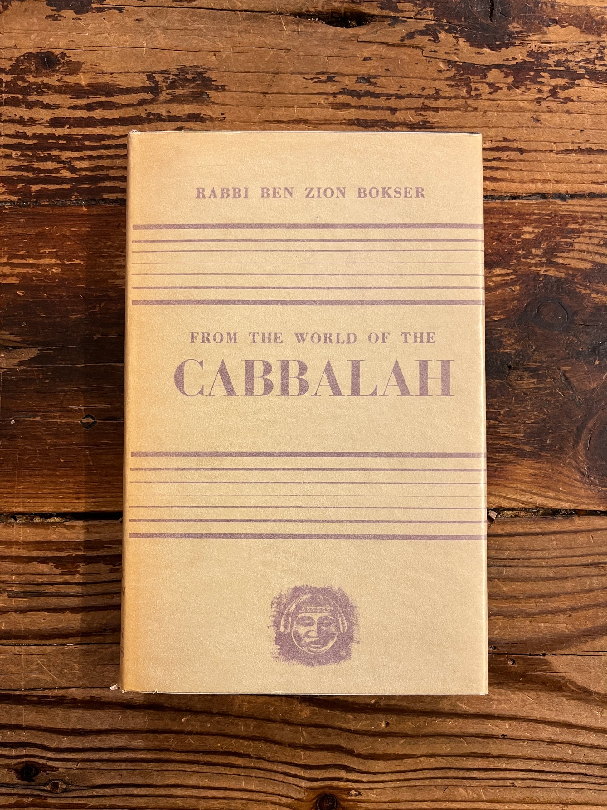 Front cover of book titled 'From the World of the Cabbalah' on a wooden surface