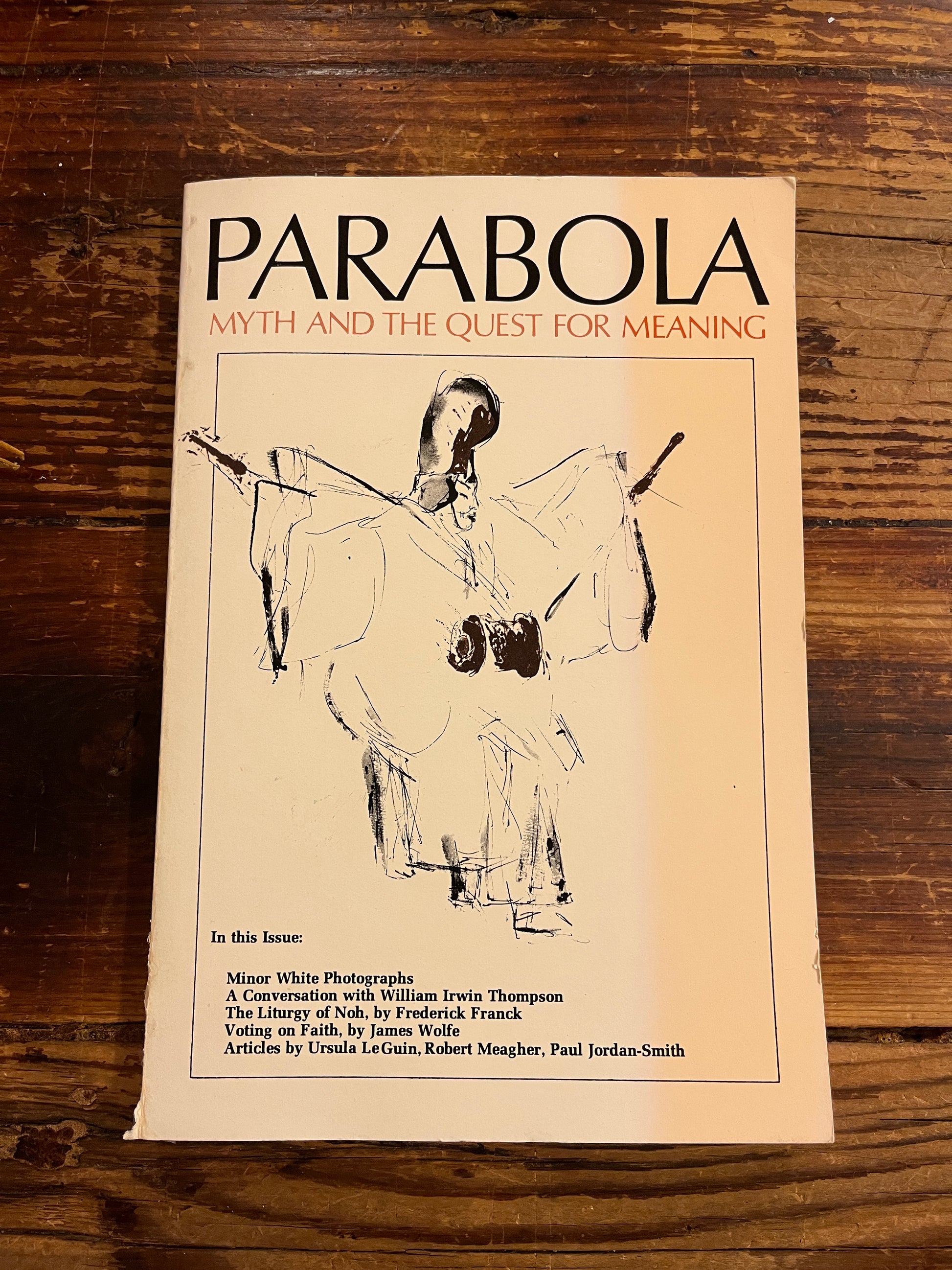 Front cover of magazine 'Parabola' on a wooden surface