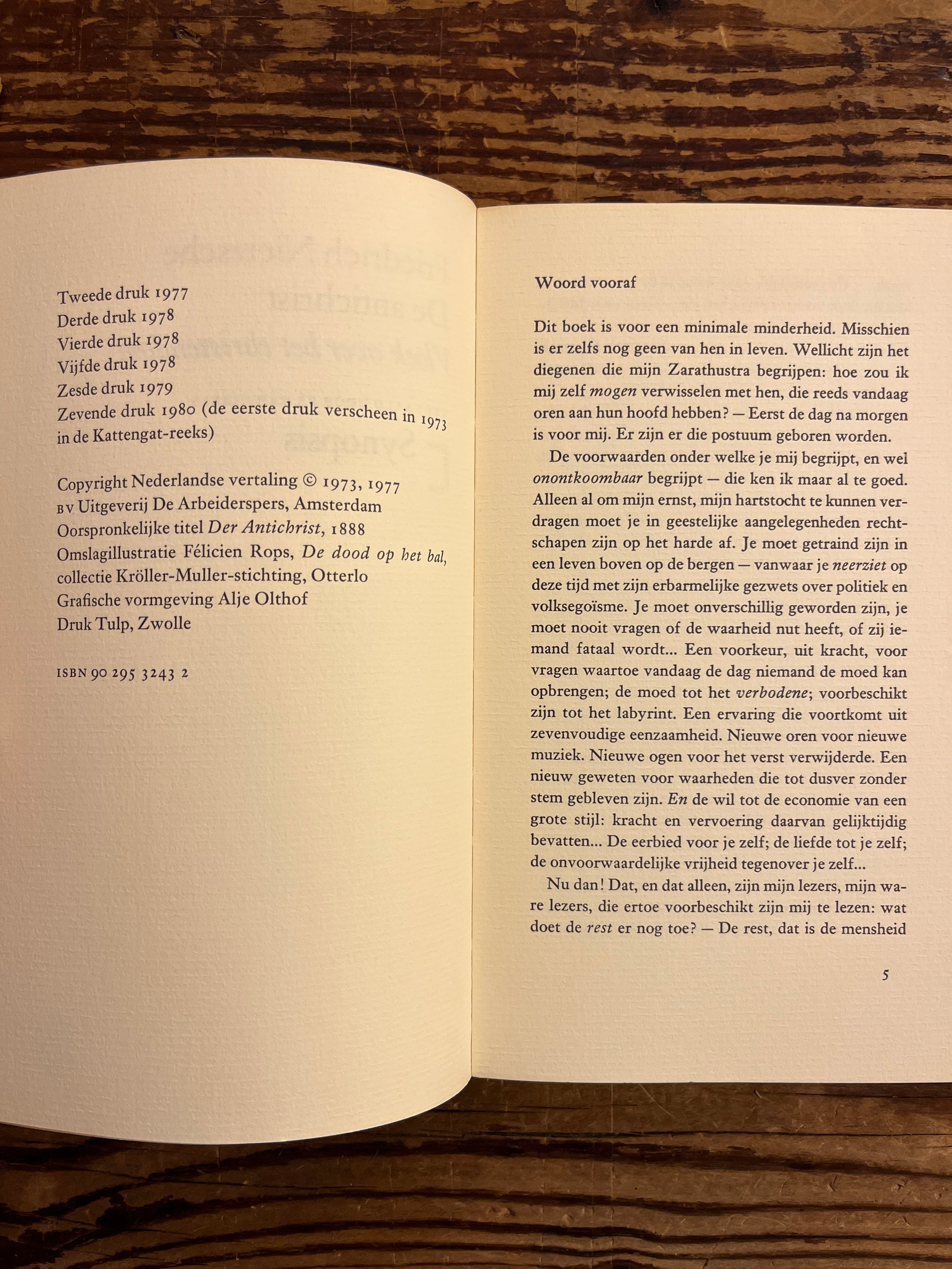 Open book on a wooden surface with text visible