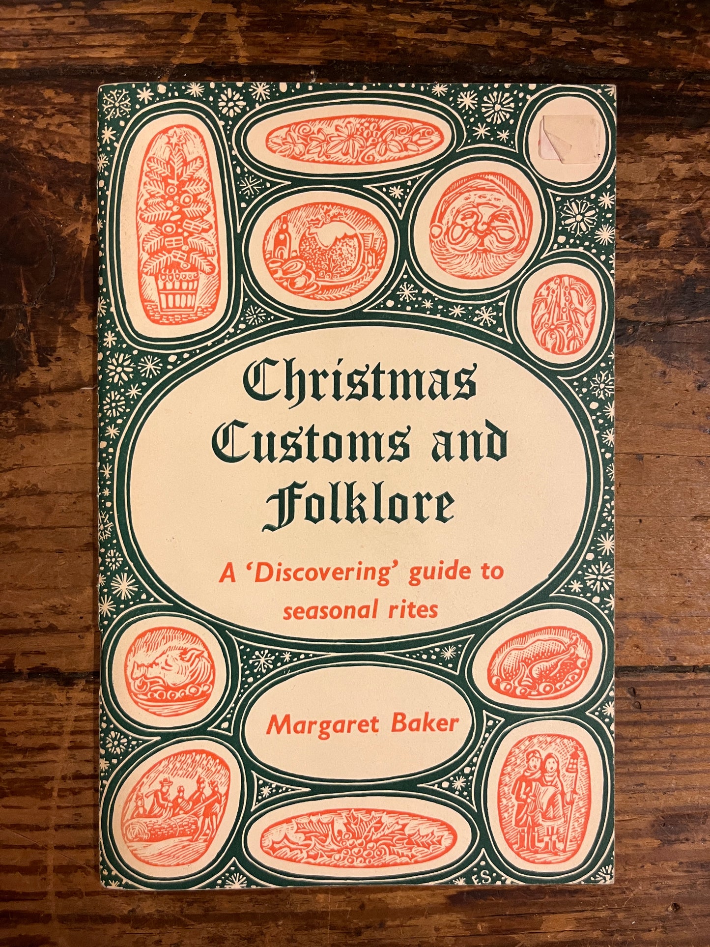 cover of the booklet "Christmas customs and folklore" on wooden background