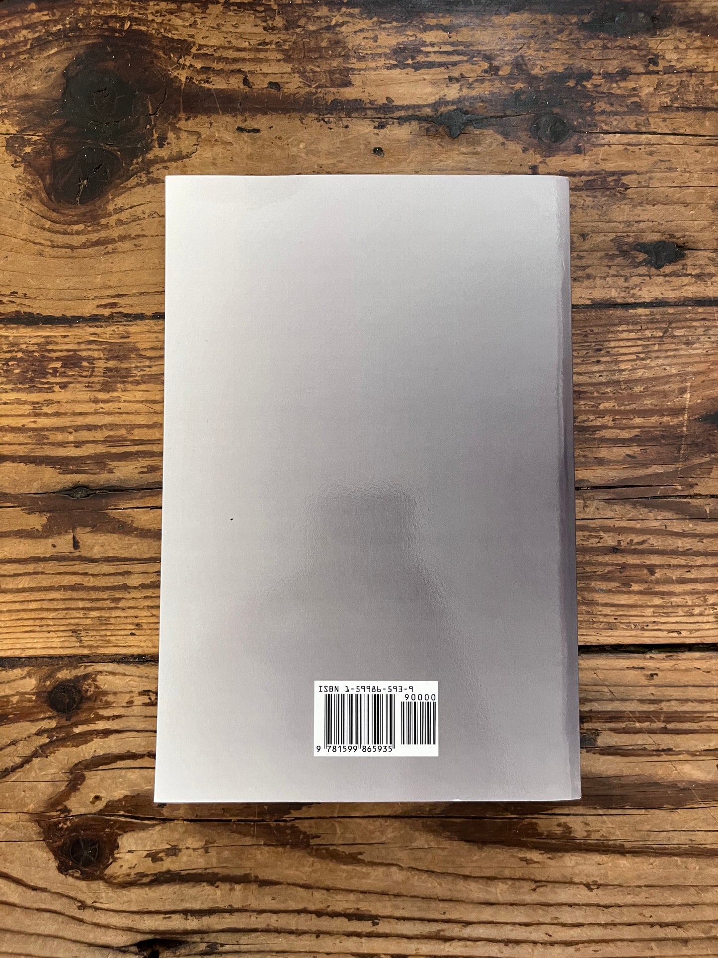 photo of the cover of the book "theory of moral sentiments" on a wooden background 