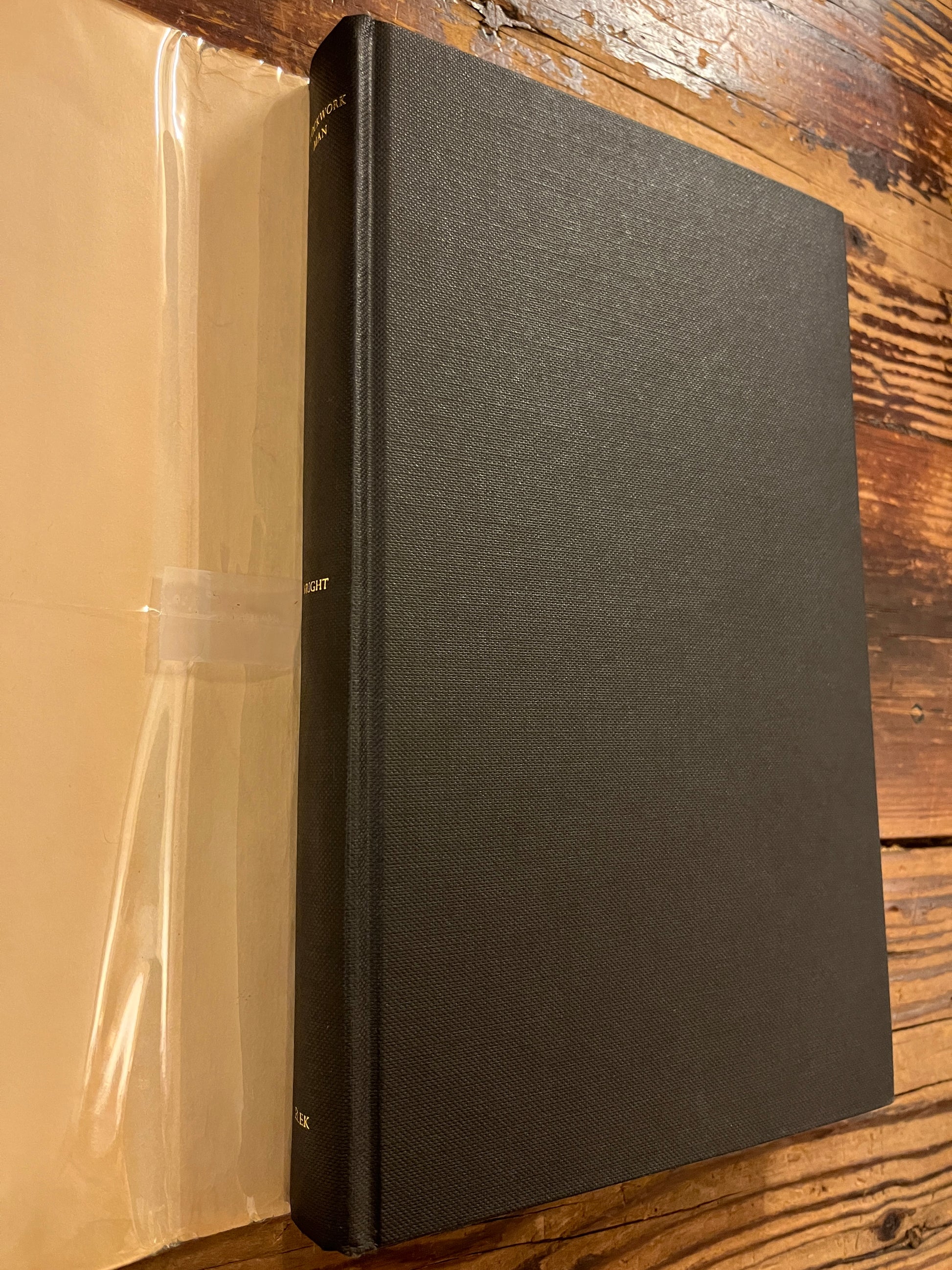 Book 'clockwork man' by Lawrence Wright without dust jacket on a wooden surface