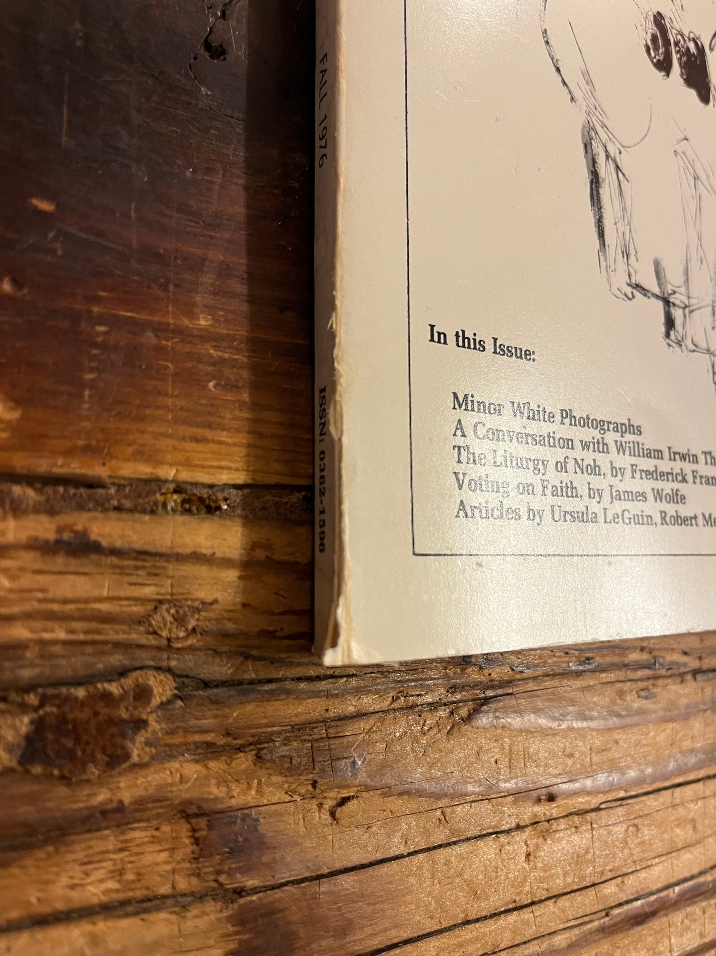 Spine of magazine titled 'Parabola' showing wear and tear on a wooden surface