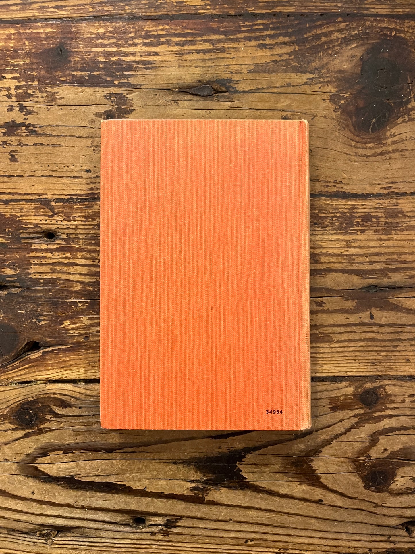 Back cover of book titled 'Yatenga' by Peter B. Hammond on a wooden surface 