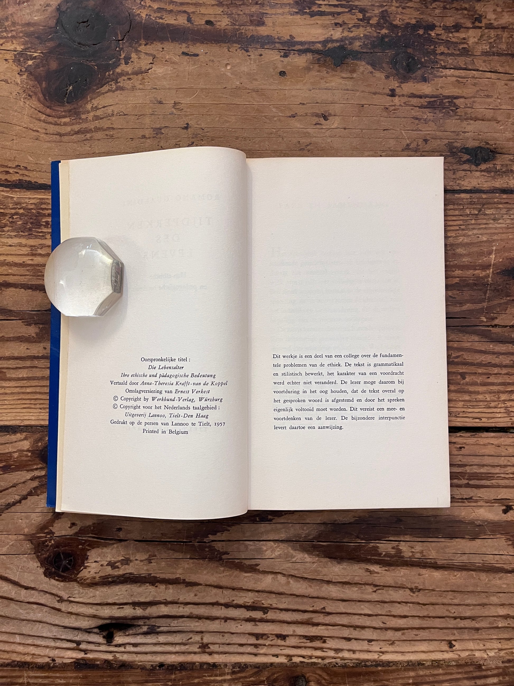 foto van de halftitel pagina van het boek "Tijdperk des levens" op houten achtergrond