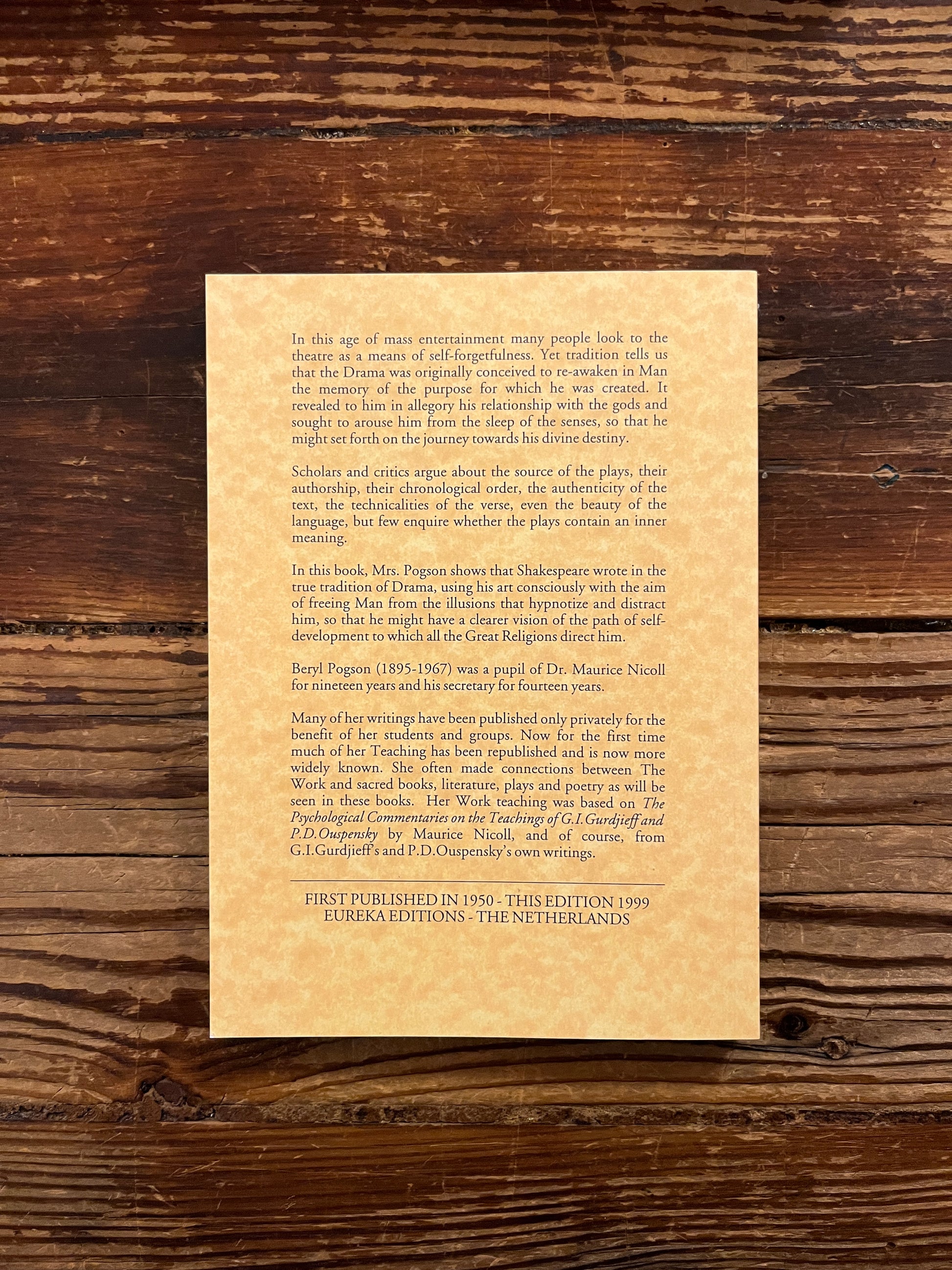 Back cover book titled 'In The East My Pleasure Lies' by Beryl Pogson on a wooden surface