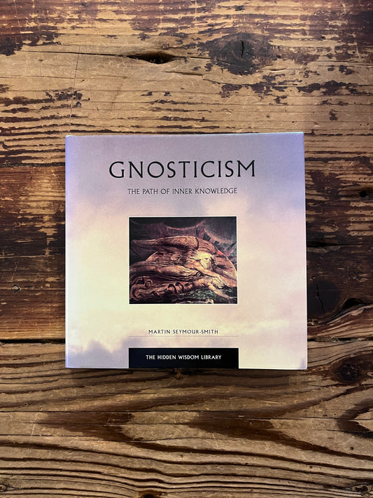 Front cover of a book titled 'Gnosticism: The Path of Inner Knowledge' by Martin Seymour-Smith on a wooden surface 